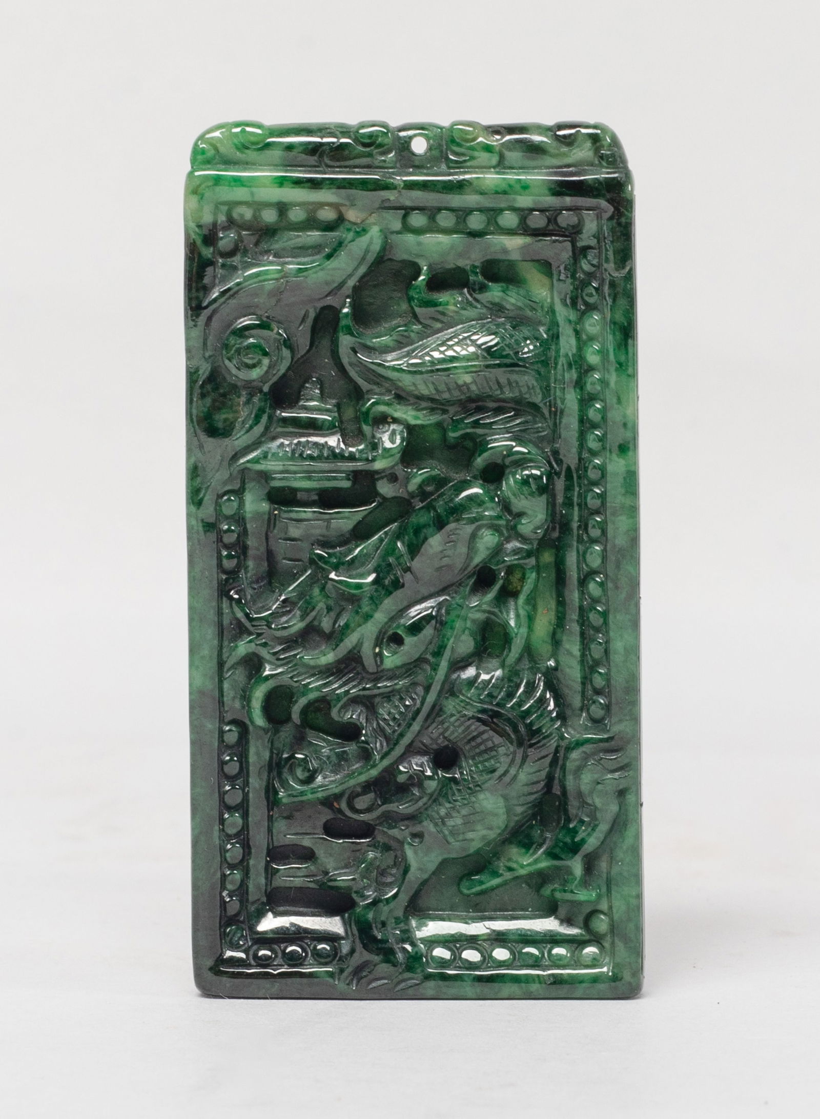 Estate Vintage Chinese Export Jade Pendant: Of rectangular shape, one side carved in raised relief with a sinuous dragon, the reverse carved with lingzhi and leaves. Approx. 2.7*1.4 inch.