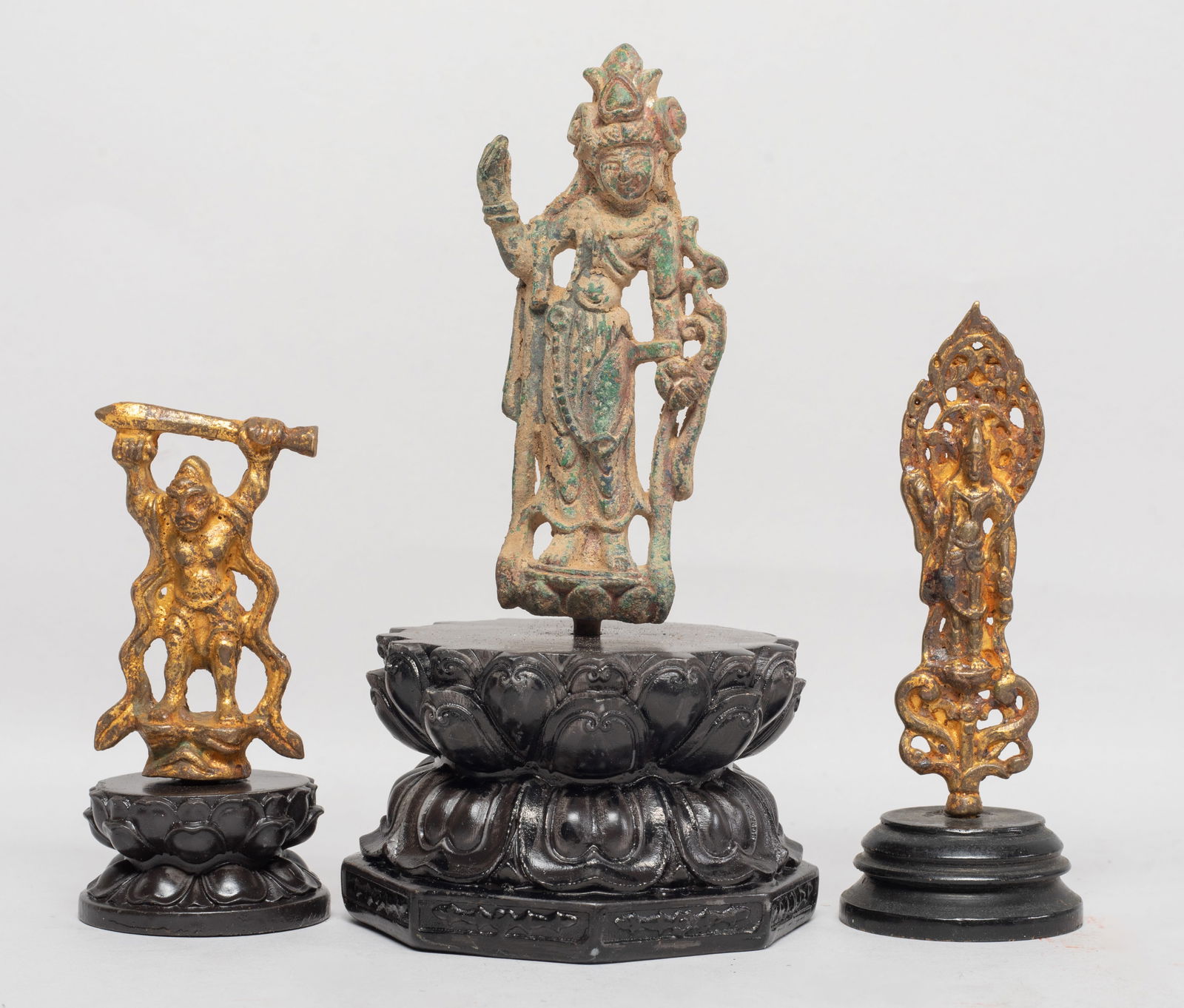 Set Chinese Bronze Sculptures of Buddha: Set of three Chinese bronze cast Buddha sculptures, one cast in elegant pose, one with hands holding implements, the other with hands holding a sword, each with a stand. Approx. 5.6*3.1 inch (largest