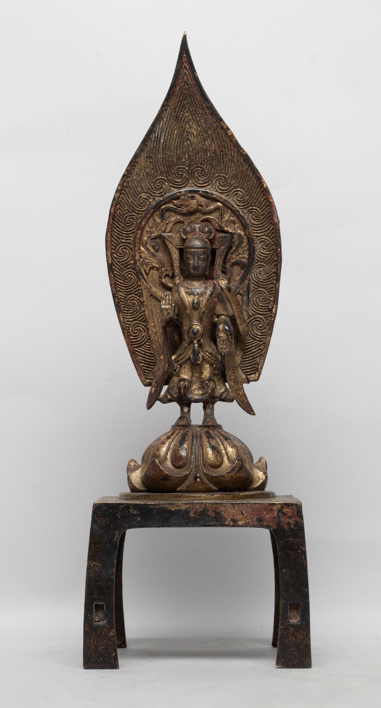 Chinese Gilt Bronze Sculpture of Buddha: The Buddha cast standing on a lotus and a square pedestal, the hands in abhaya mudra pointing to opposite directions, the back with a flame shaped mandorla. Approx. 11.5*4*4 inch.