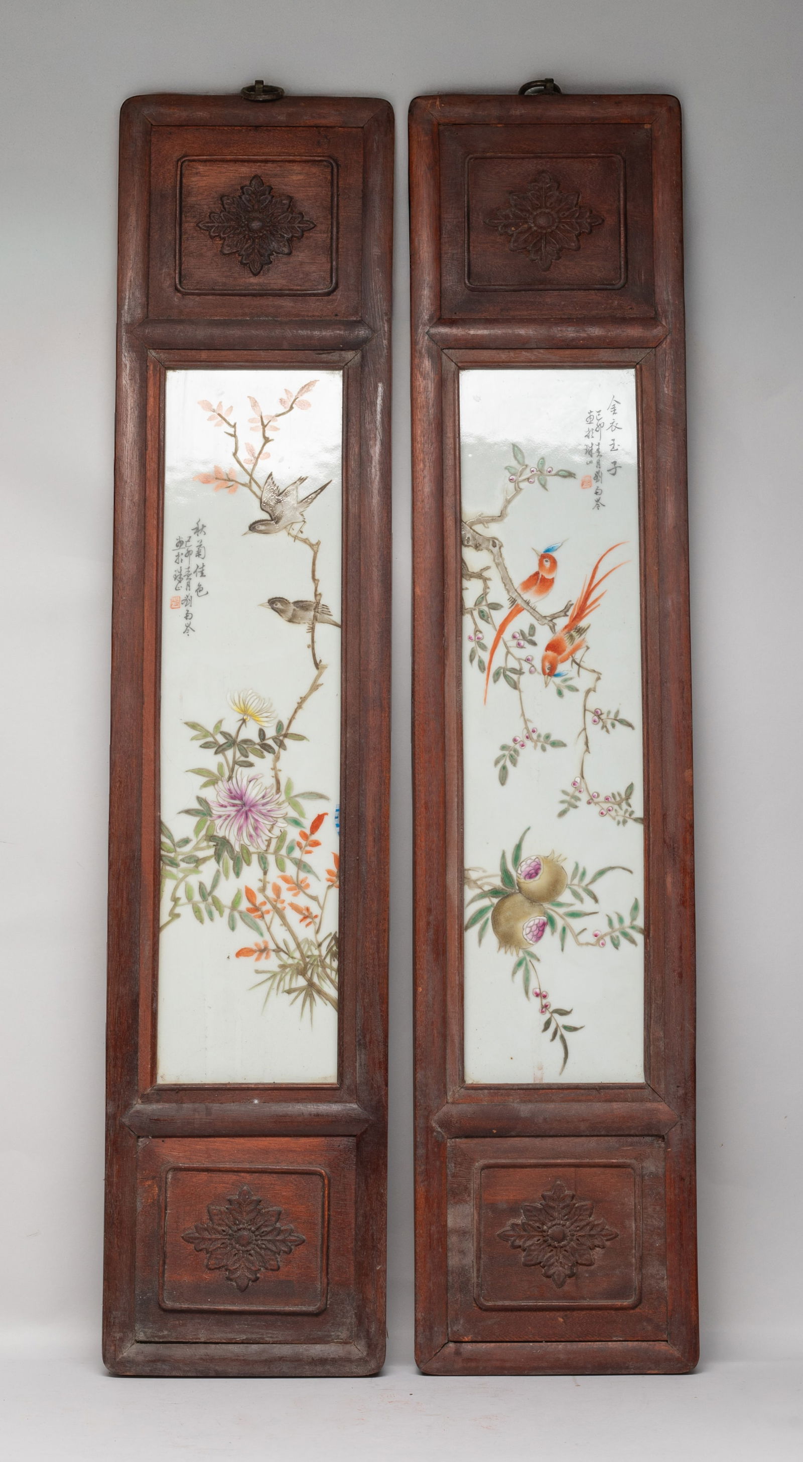 Two Chinese Wood Inlaid Wall Hanging Plaques: Two Chinese wood wall hanging decors inlaid with porcelain plaques, one painted with birds and chrysanthemum, the other with birds and pomegranate, inscribed with related passages. Approx. 31*6.6 inch