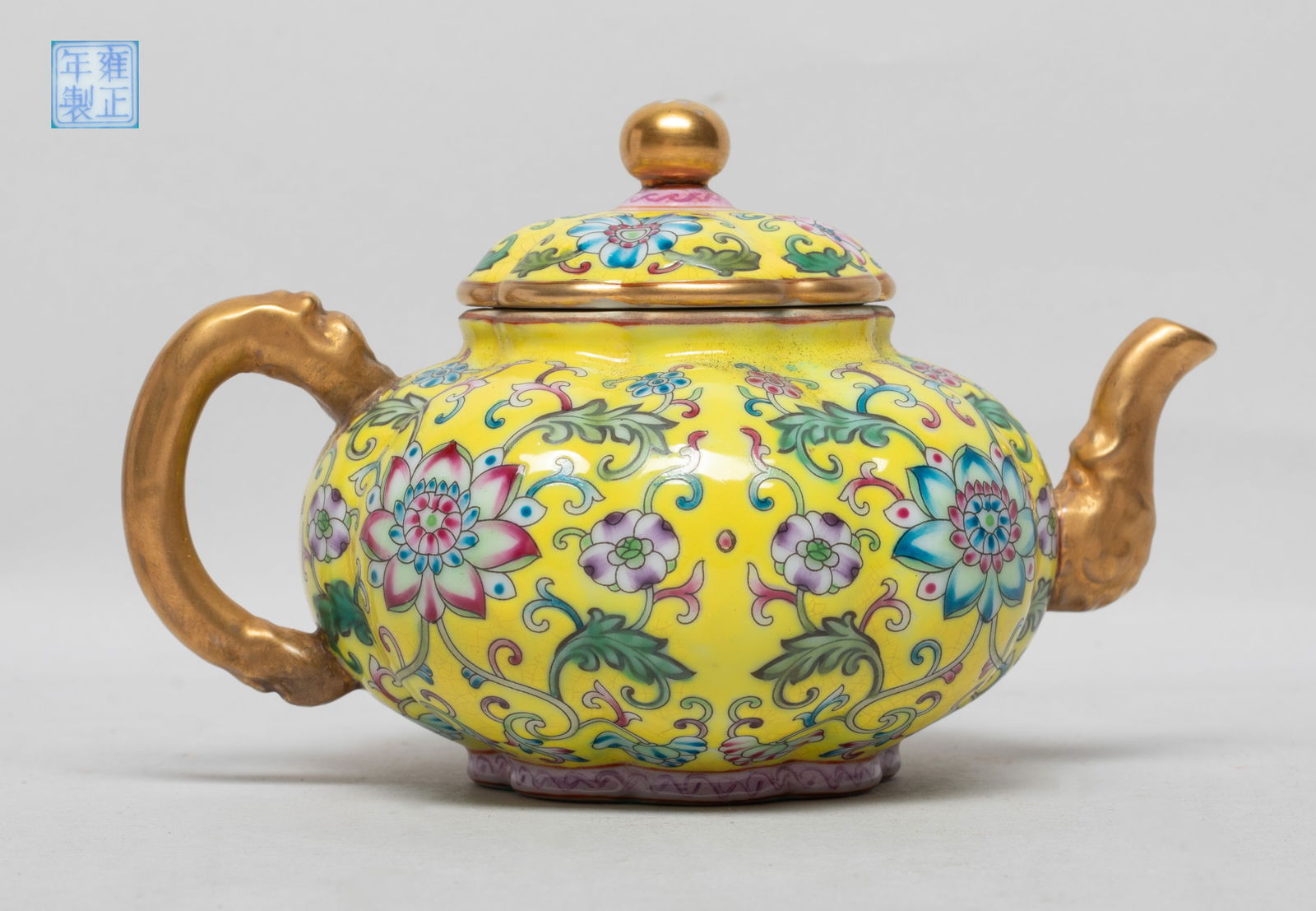 Chinese Enameled Porcelain Tea Pot: Of pumpkin shape, the exterior decorated with dense lotus foliage on bright yellow background, the interior and the bottom turquoise glazed, the bottom with a seal mark. Approx. 6*4.1*3.7 inch.