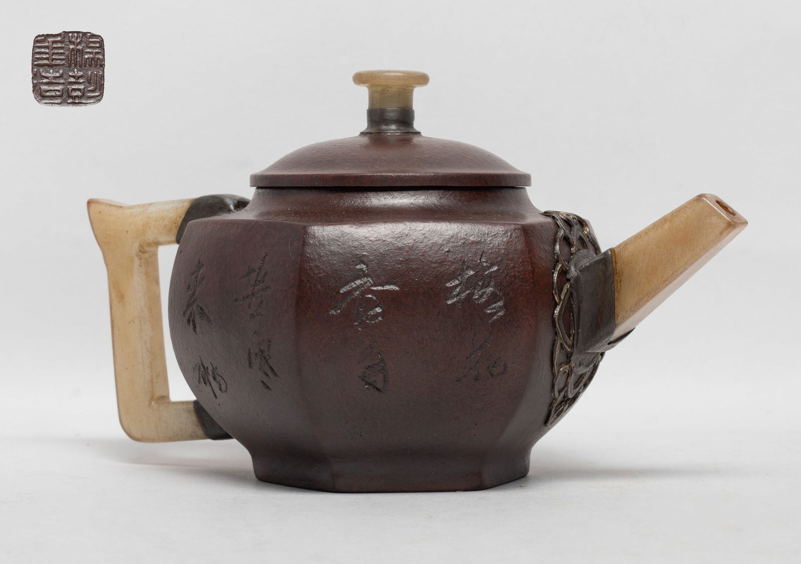 Vintage Chinese Yixing Zisha Tea Pot: Of hexagonal section, the body carved with plum blossoms and inscribed with poems, with stone handle, spout and lid knob, the bottom with a seal mark. Approx. 6.3*4*3.7 inch.