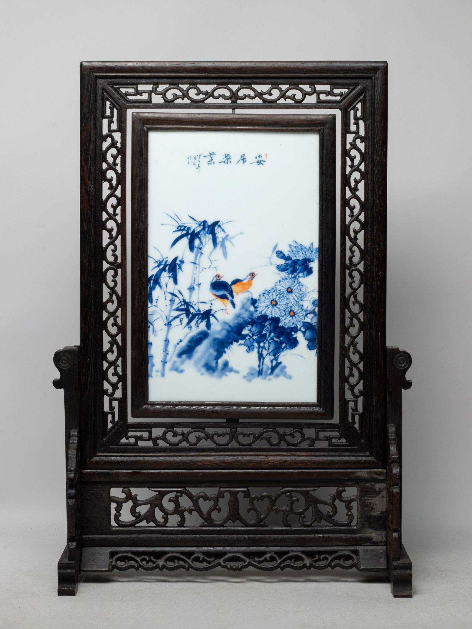 Vintage Chinese Wood, Porcelain Table Screen: Chinese wood table screen of rectangular shape, inset with a blue and white porcelain plaque painted with a pair of birds among chrysanthemums and bamboo, inscribed with related passages. Approx. 12*4