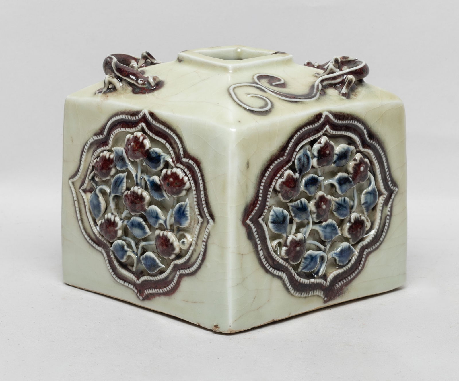 Chinese Blue, White & Red Porcelain Water Pot: Of square section, each side carved with a ruyi head enclosing leafy foliage, two raised chi dragons sinuous around the mouth. Approx. 4.6*4.6*4.1 inch.