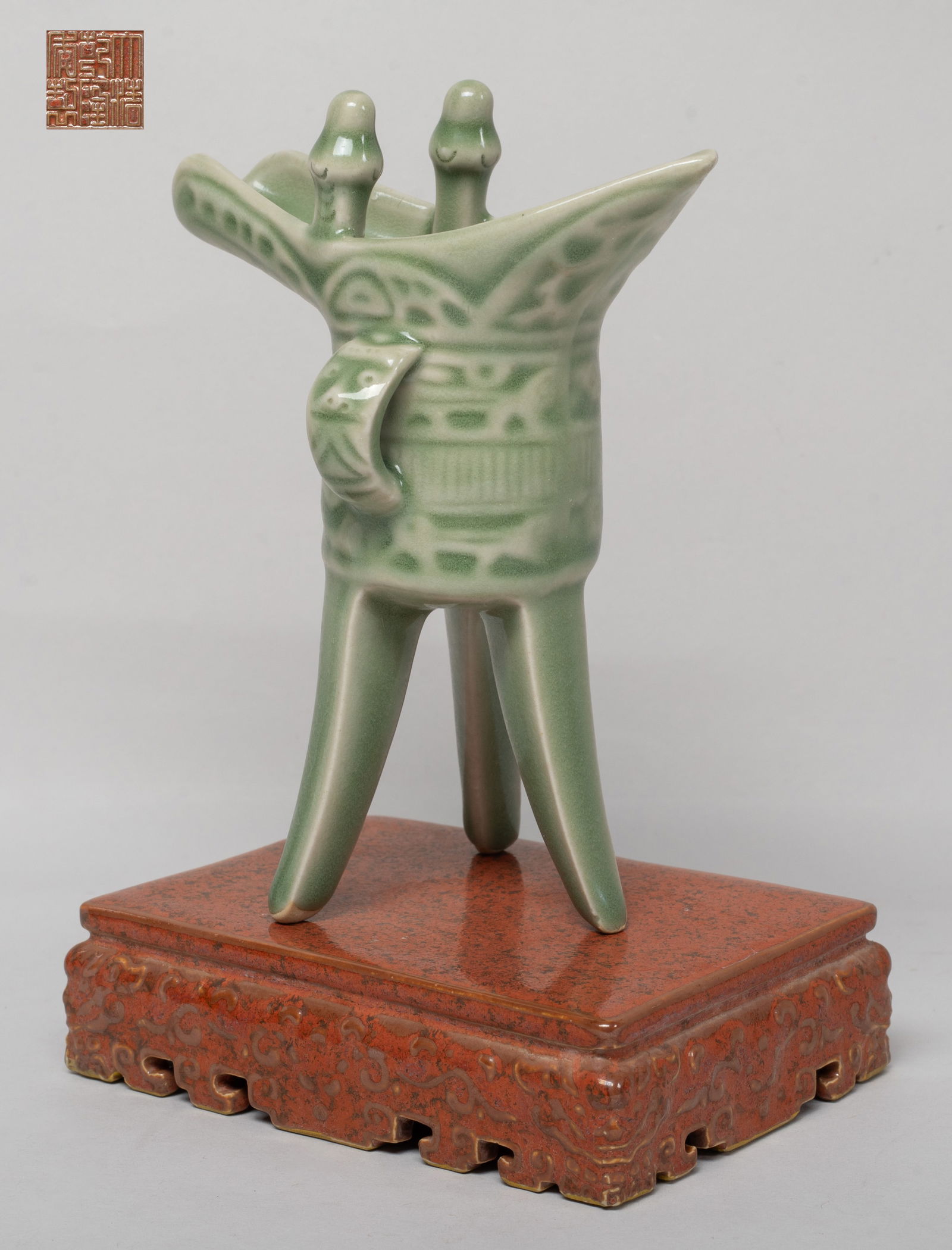 Chinese Export Porcelain Tall Cup w/ Base: Raised on three elegant flange supports, carved in low relief with archaistic motif below the U-form spout and paired rails capped by whorl-decorated finials set off at the back by a pointed collar an