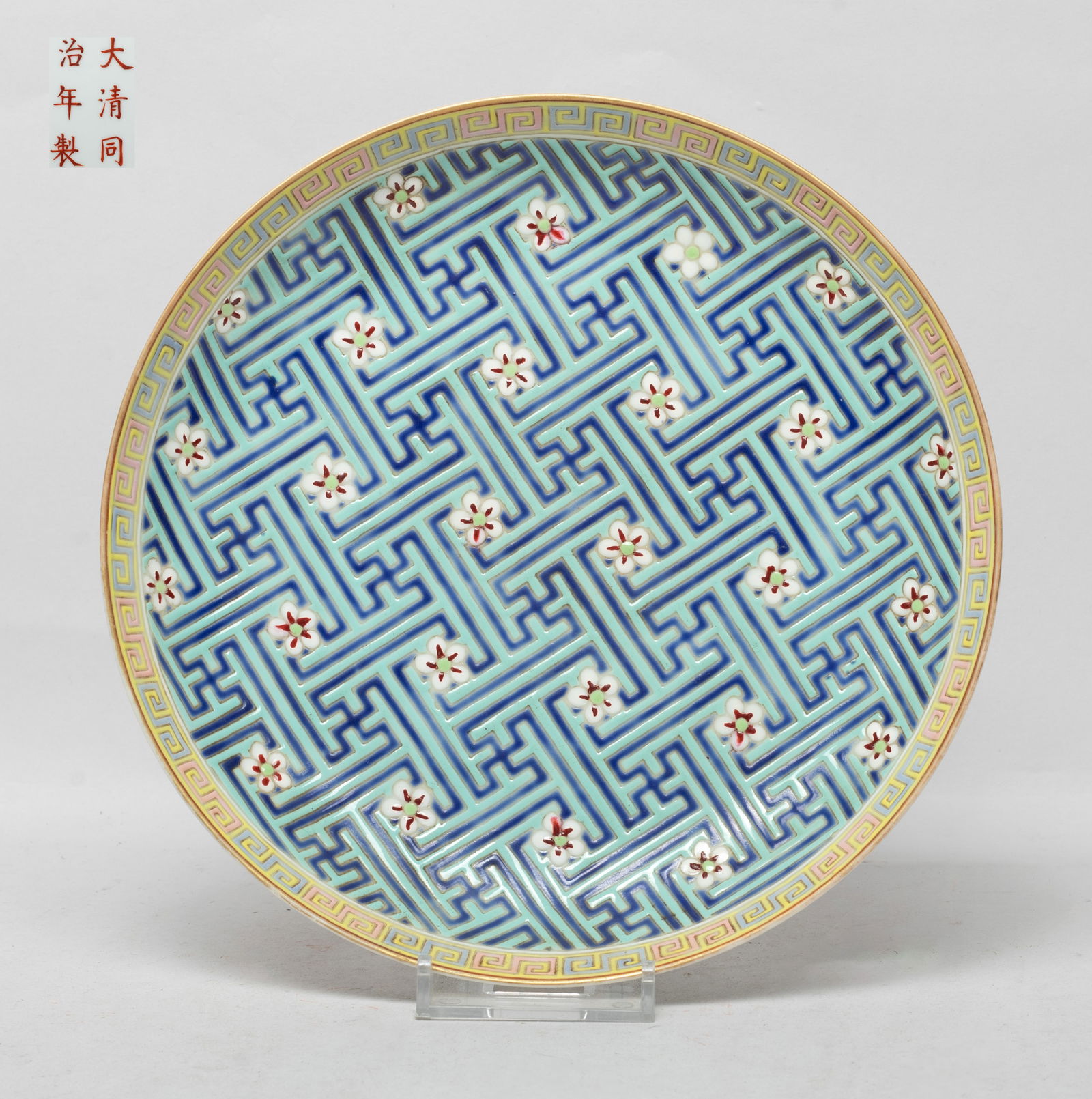 Chinese Enameled Porcelain Plate: The plate interior enameled with plum blossoms over turquoise and dark blue glazed fret background, the rim with a band of scrolls, the exterior painted with five copper-red bats, the bottom marked wi