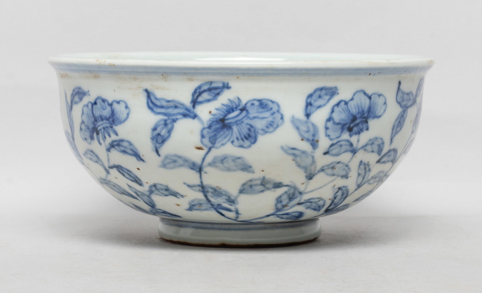Collectible Chinese Export Porcelain Bowl: The bowl exterior painted with leafy stems issuing blossoming flowers. Approx. 5.6*2.6 inch.