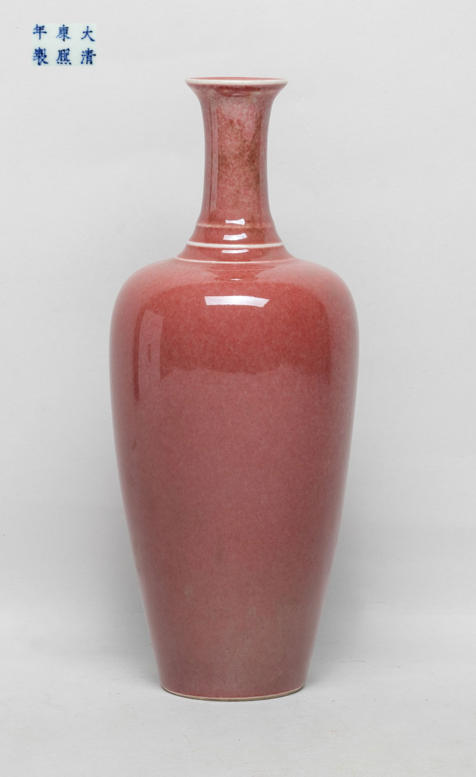 Collectible Chinese Red Glazed Porcelain Vase: Of baluster form with a cylindrical neck and a flared rim, the inside and out covered in mottled copper red glaze, the bottom marked with six characters in blue glaze. Approx. 3.5*8.7 inch.