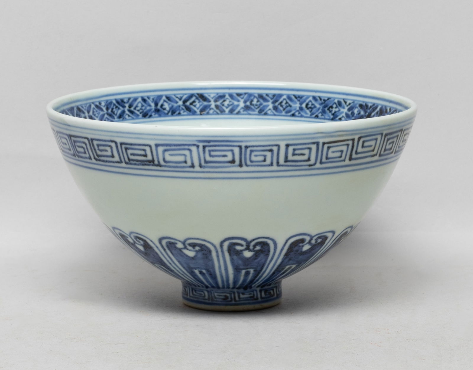 Collectible Chinese Export Porcelain Deep Bowl: The bowl interior decorated with delicate foliage patterns, the rim with a band of flowers, the exterior with a band of petals between fret borders. Approx. 6.8*3.7 inch.