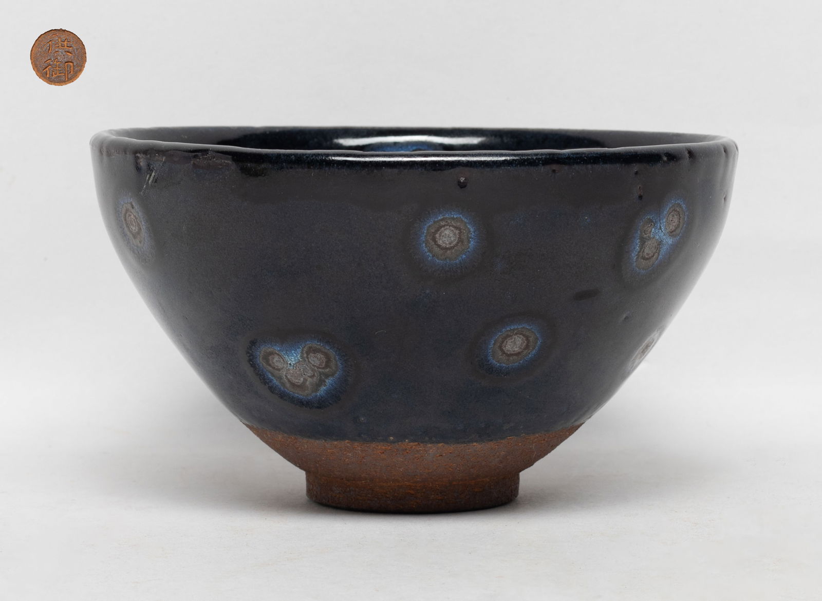 Estate Chinese Jian Type Porcelain Tea Bowl: The bowl inside and out covered in rich black glaze suffused with blue splashes and silvery 'oil spots', stopping above the unglazed foot, the bottom carved with two characters. Approx. 5.2*2.8 inch.