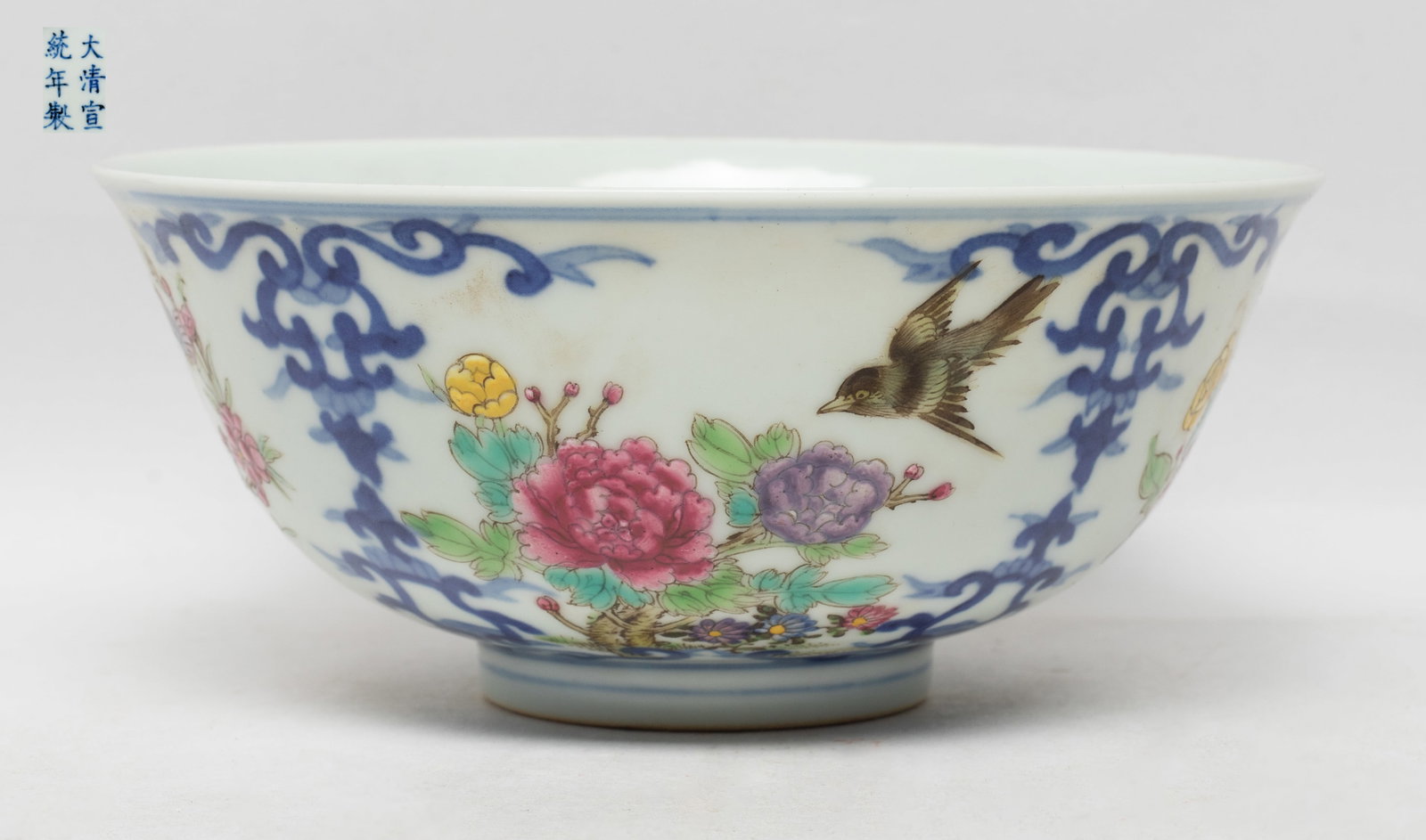 Collectible Chinese Export Porcelain Bowl: The bowl exterior enameled and painted with scenes of flowers and butterflies, or flowers and bird, divided by blue foliage scrolls, the bottom marked with six characters. Approx. 5.9*2.5 inch.