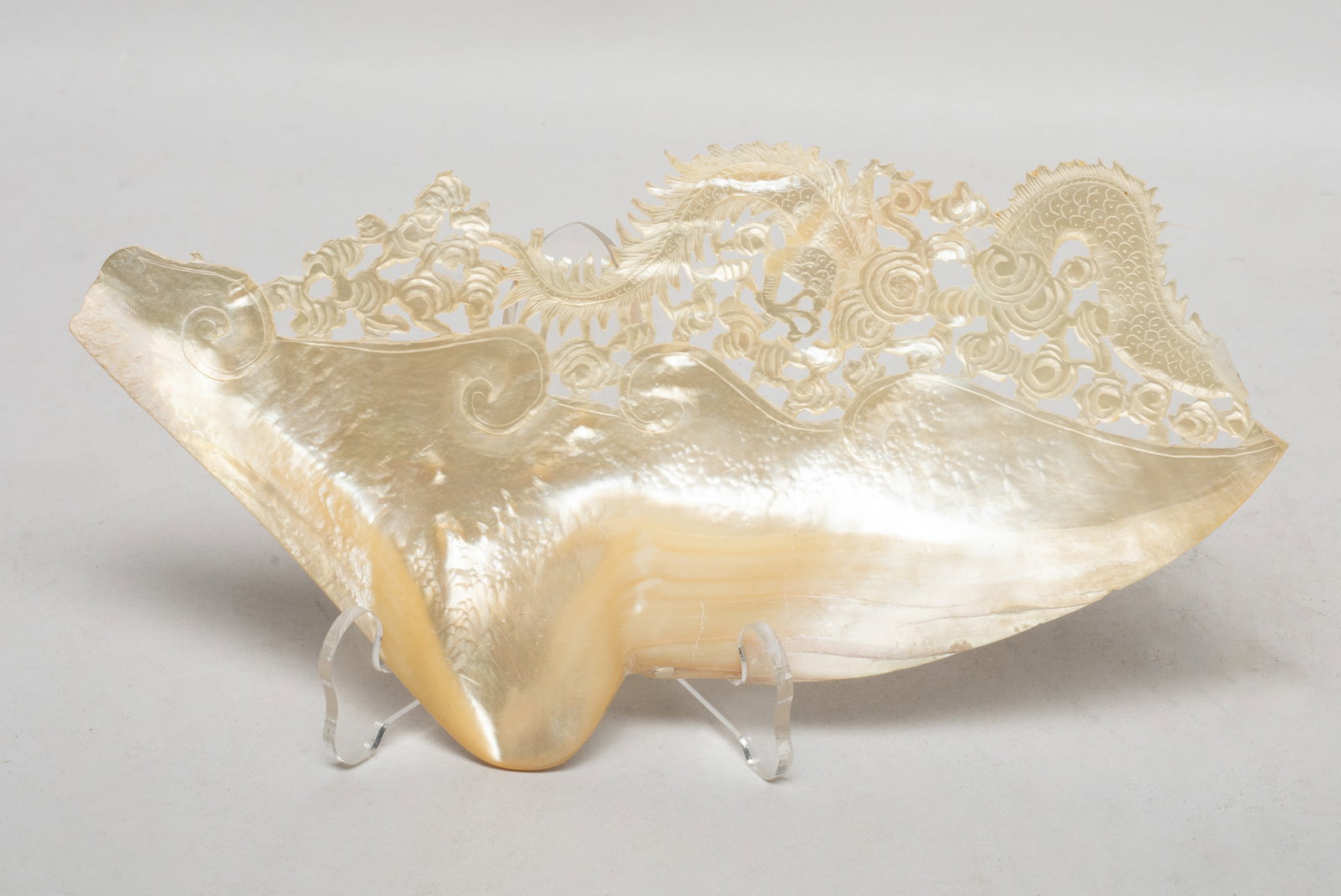 Vtg. Chinese MOP Carved Piece: Chinese mother-of-pearl piece carved in openwork with a dragon sinuous amidst clouds. Approx. 7.5*3.8 inch. The Estate of the Heritage & Moving Sale. Pasadena, CA, 2025.
