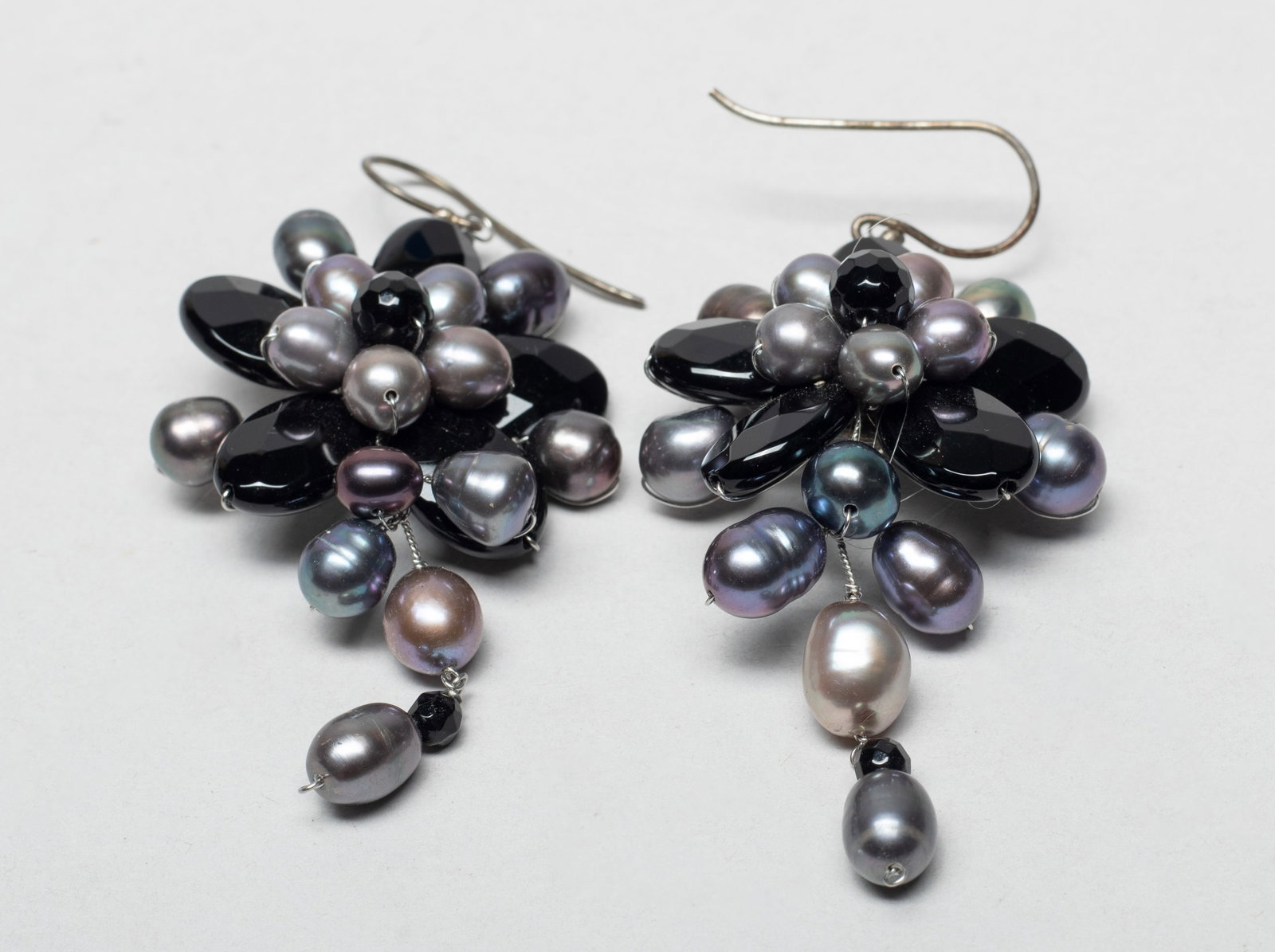 Two Large Designed Silver, Pearl Earrings: A pair of designed silver earrings of flower form, decorated with gray pearl. Approx. 2.4*1.3 inch (each). The Estate of the Tierney & Son. AZ. 2003.