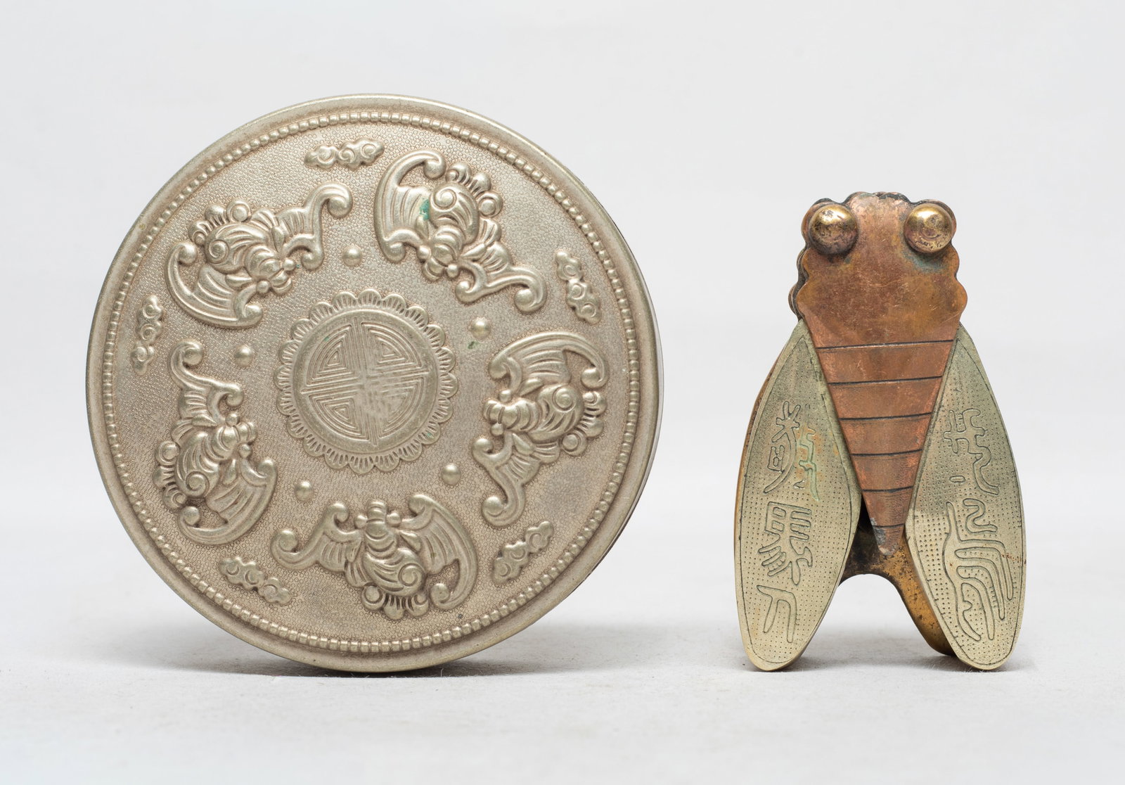 Two Chinese Export Ink Boxes: One of rounded shape, the top carved with five bats surrounding a shou character, the bottom marked four characters, the other of cicada form, the bottom marked with three characters. Approx. 3.2*1.3 