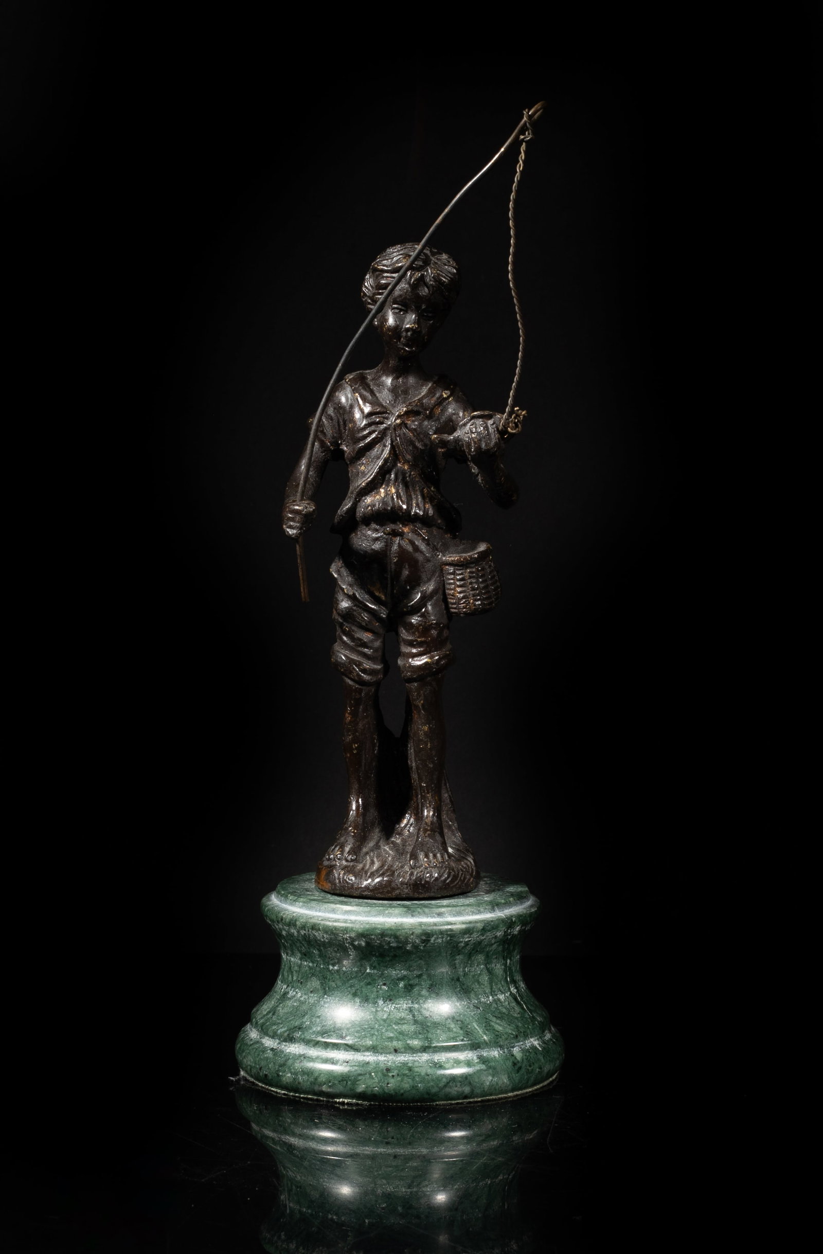 Vtg. Bronze Fishing Boy w/ Marble Base: Cast as a standing fishing boy, his right hand holding a fishing rod and left hand grasping a fish, with a circular marble base. Approx. 3.6*9 inch.