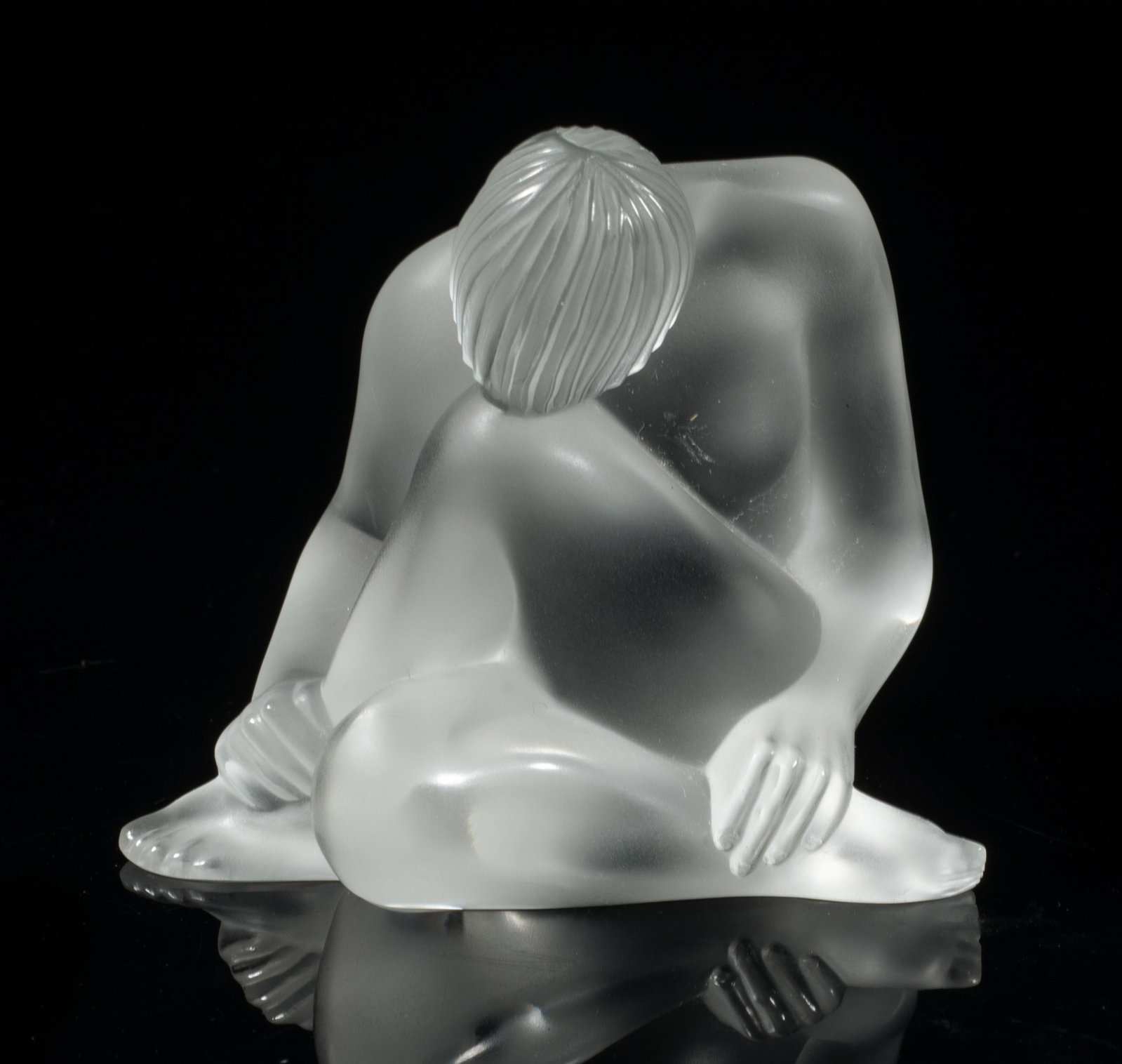 Estate Lalique Crystal Glass Sculpture: Lalique crystal glass table sculpture moulded as a seated figure with legs crossed, the underside etched Lalique France. Approx. 2.8*2.5*2.3 inch.