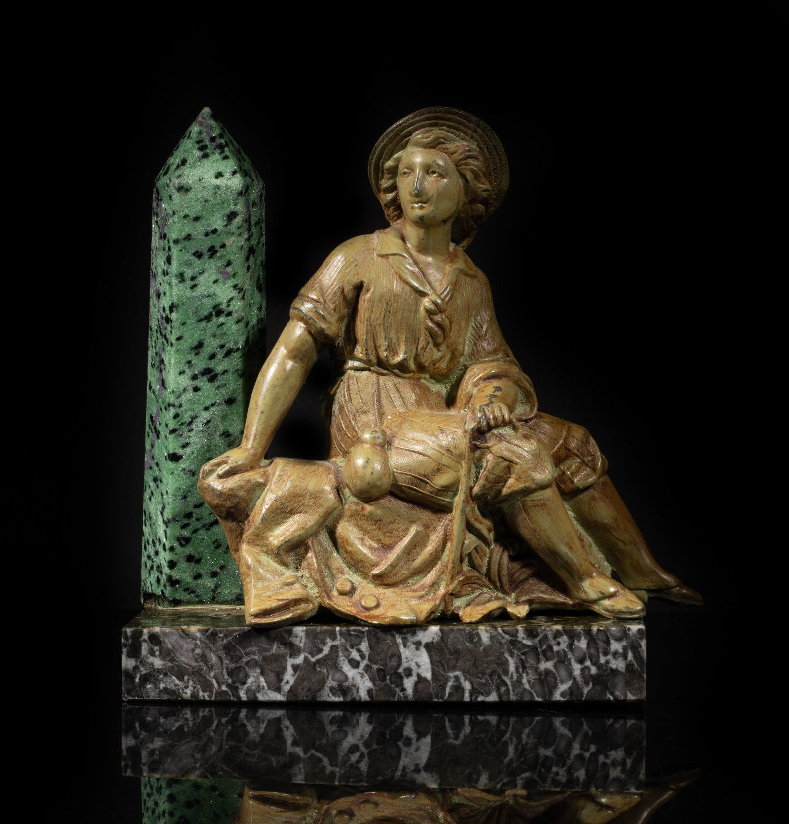 Ruby Obelisk, Metal, Marble Base Sculpture: A metal sculpture moulded as a seated man and aa ruby obelisk, with a rectangular marble base. Approx. 6.5*6.3*2.8 inch.