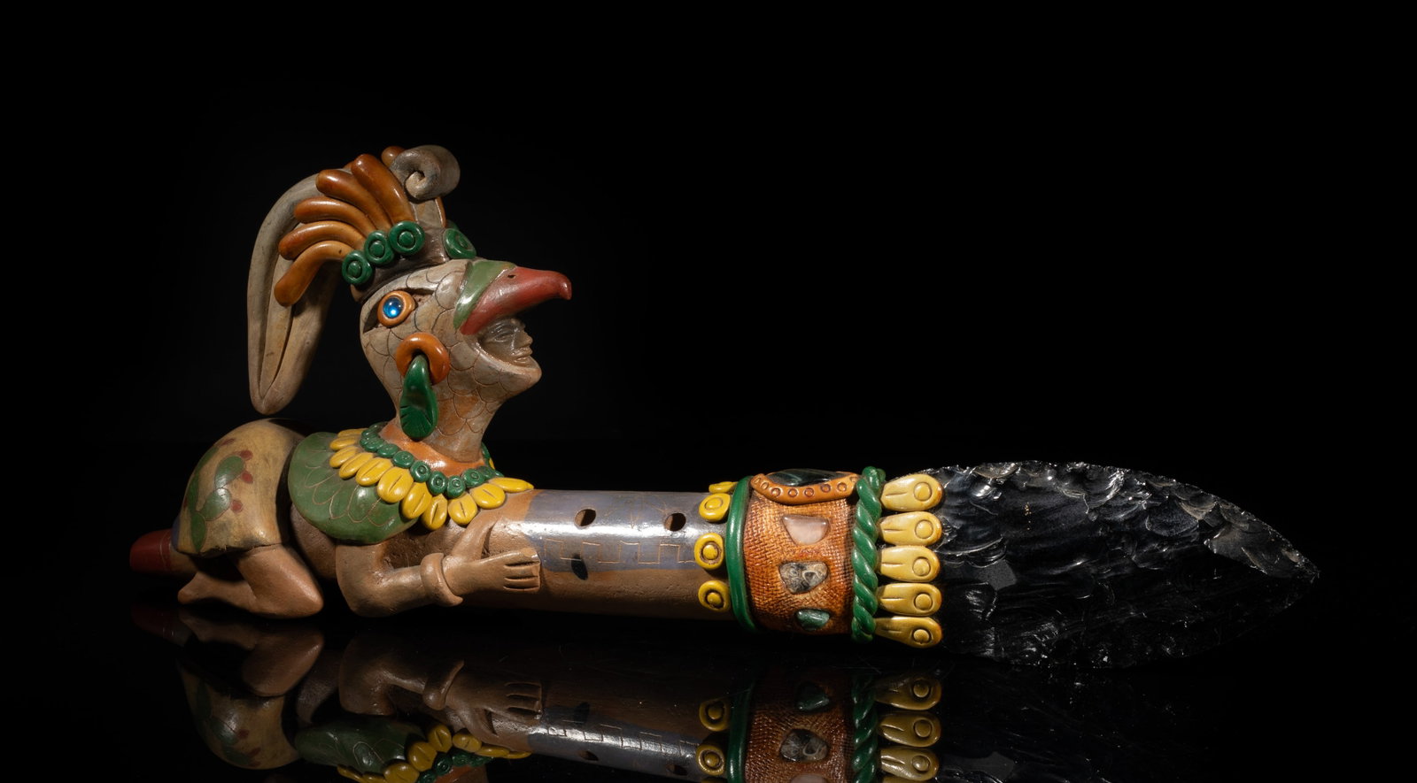 Aztec Style Mexican Jet Stone, Pottery Sculpture: Aztec-style Mexican jet stone, gemstone and pottery sculpture, molded as a figure wearing a rooster hat, kneeling on and carrying a long point tool. Approx. 16*6.2*3 inch.