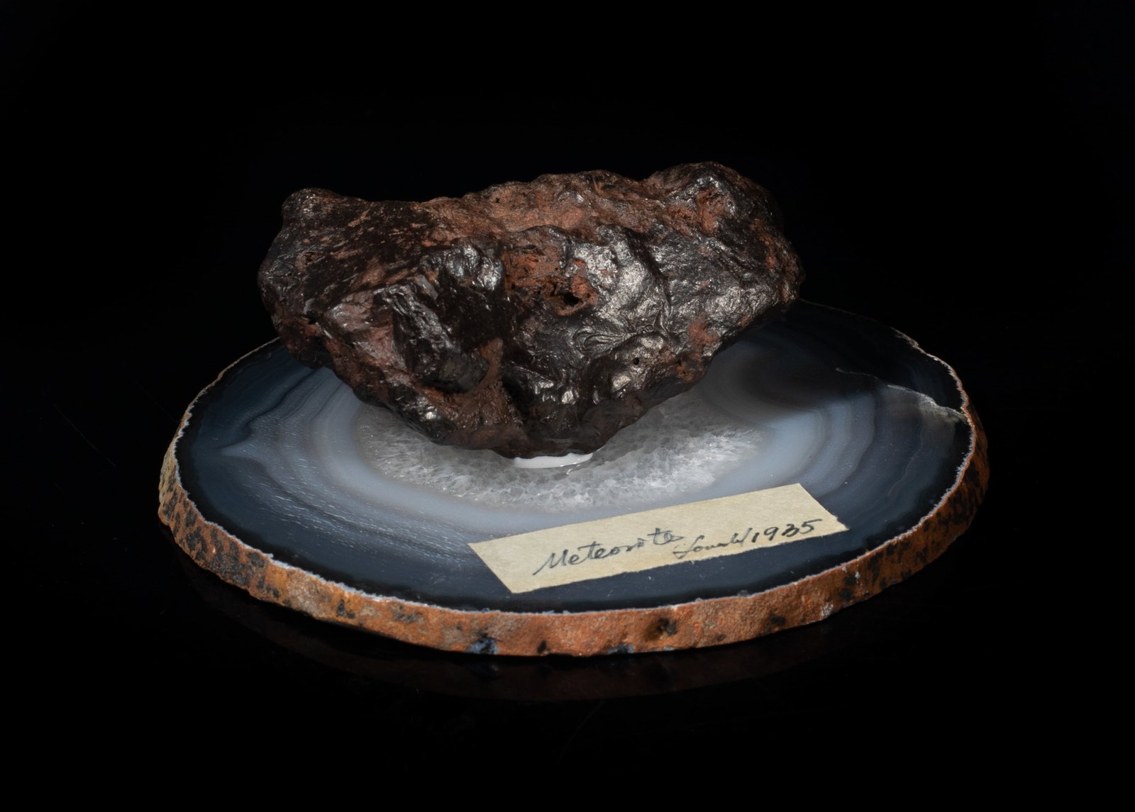 Rare Iron Meteorite on Agate Base: Rare iron meteorite sculpture with an agate slab base. Approx. 4.2*3.95*1.4 inch.