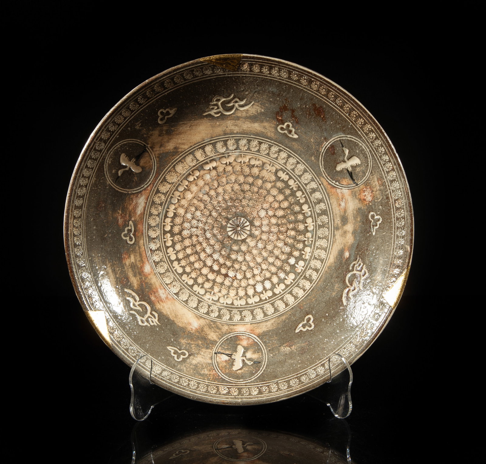 Large Vintage Korean Hand Made Porcelain Charger: The glazed porcelain charger interior carved and painted with a band of cranes flying amidst clouds, surrounding a central panel of flowers. Approx. 11*2 inch.