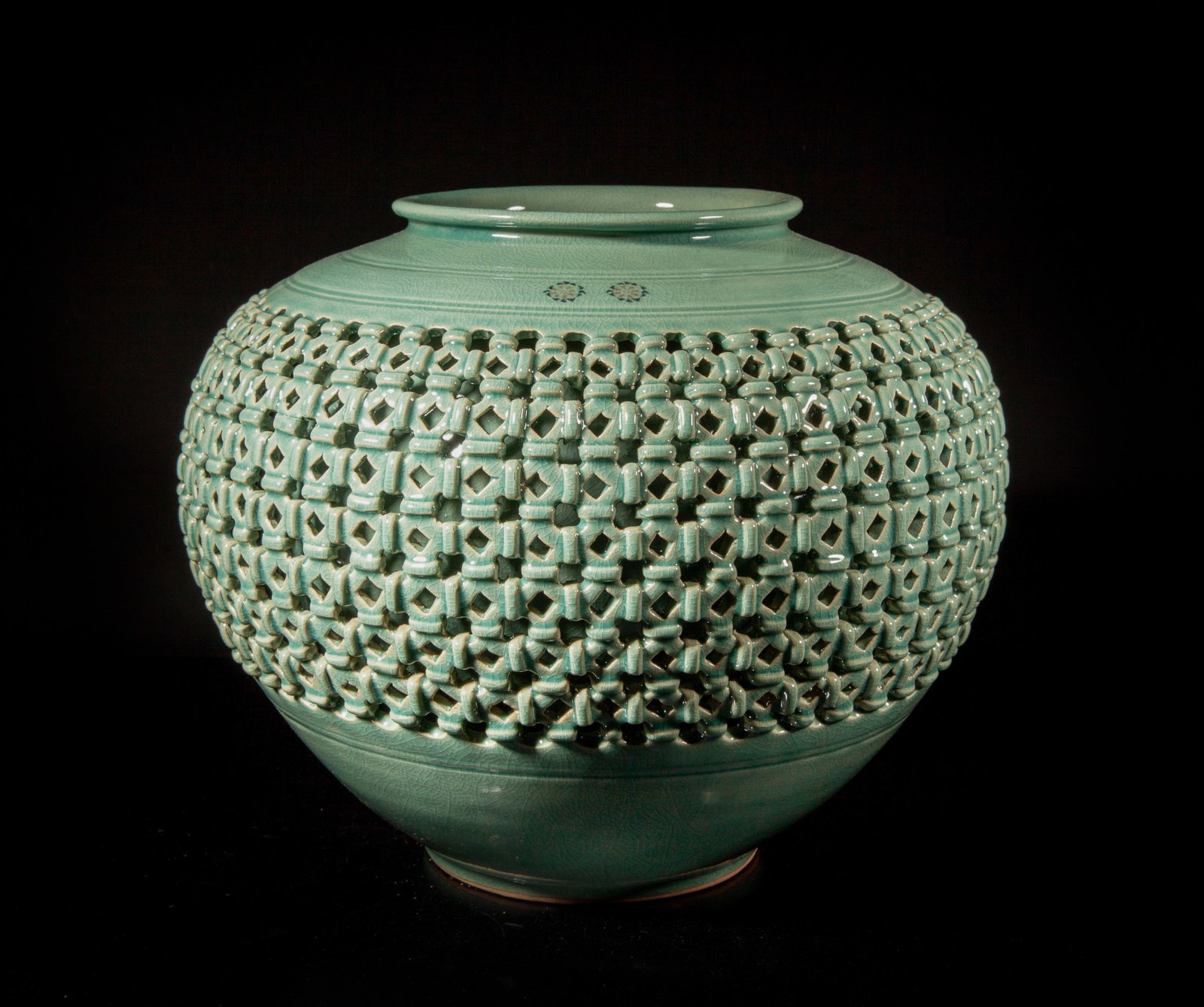 Massive Korean Celadon Glazed Porcelain Vase: Of tapered ovoid form with reticulated body, overall covered with crackled celadon glaze, the bottom marked with two characters and a seal. Approx. 13.7*11 inch.