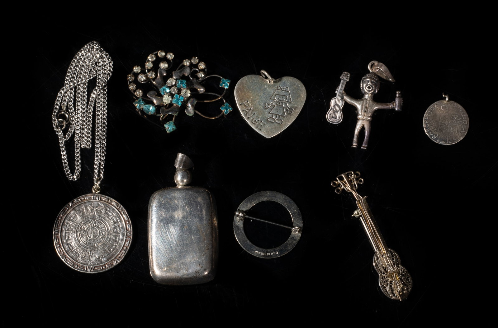 Group Vintage Sterling Silver Pendants: Including a necklace, three brooches and four pendants, wherein two pieces marked STERLING, three pieces marked 925, and the other three pieces with no mark. Approx. 77 gram (total weight), 19 inch L