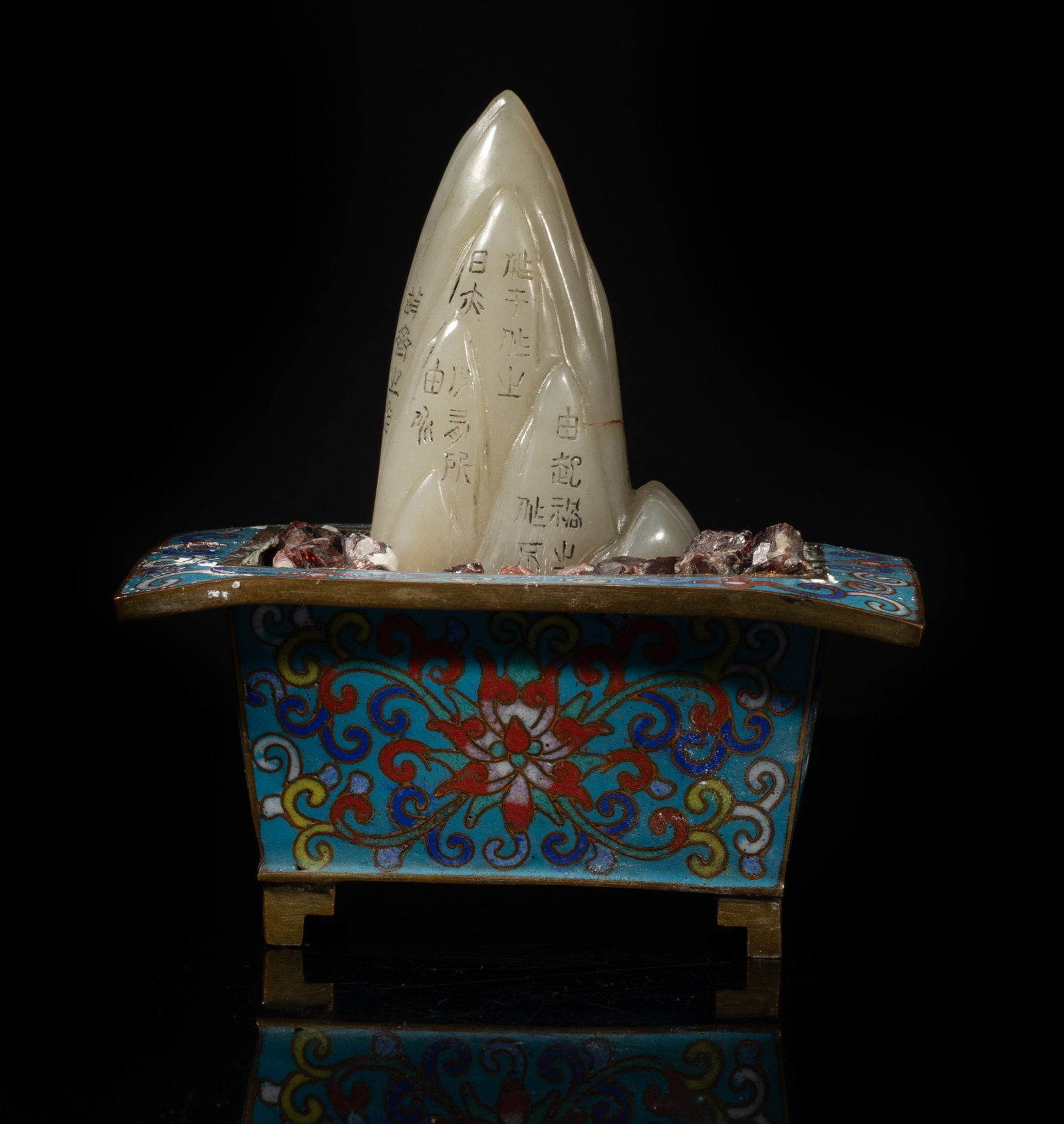 Chinese Jade, Garnet Bonsai Sculpture: Chinese jade bonsai sculpture of mountain shape, incised with stylized characters, and garnet stone pieces, with a cloisonne pot enameled with floral scrolls on blue ground. Approx. 5*4.5*3.3 inch.