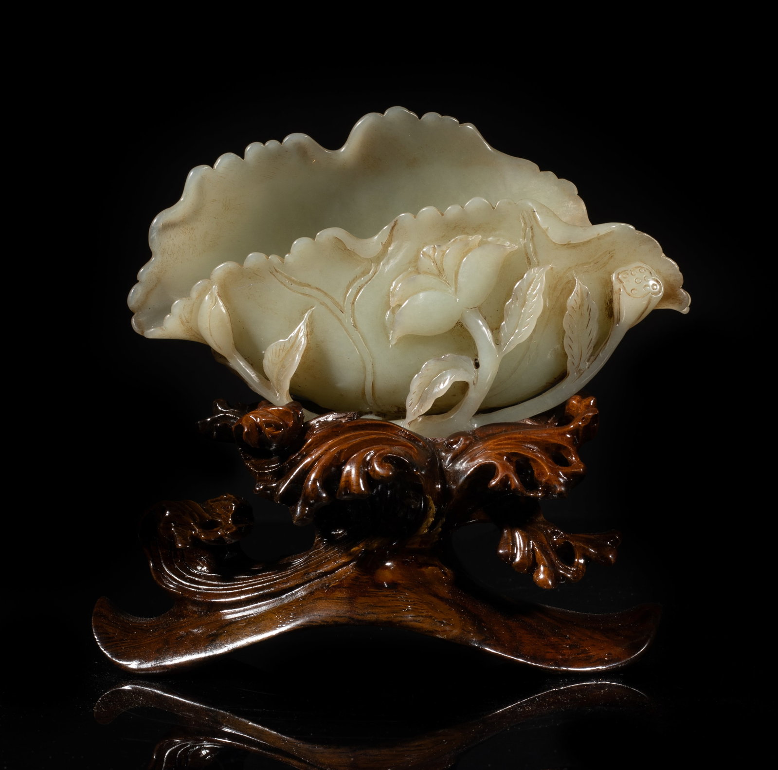 Large Chinese Jade Carved Washer on Stand: Crisply carved and hollowed as an undulating lotus leaf with finely incised veins, issuing from long curling stems forming the base and issuing further smaller leaves, a blossoming lotus flower and a