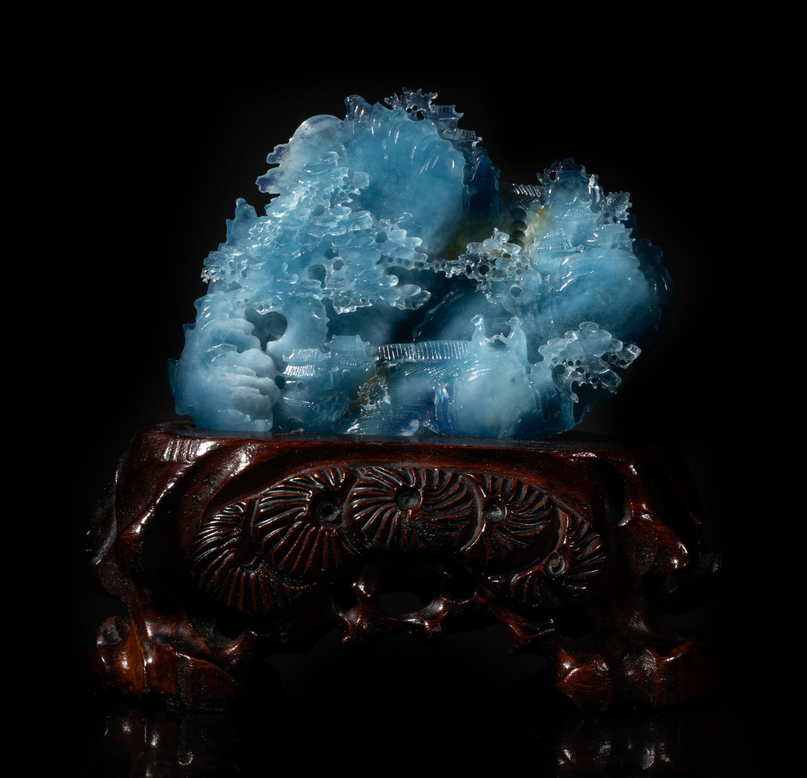 Vintage Chinese Aquamarine Table Sculpture: Carved in varying levels of relief as a craggy mountainscape encompassing a flowing stream, scattered pine trees, bridges and pavilion, with a wood stand. Approx. 4.8*3.6*1.5 inch (w/o stand).