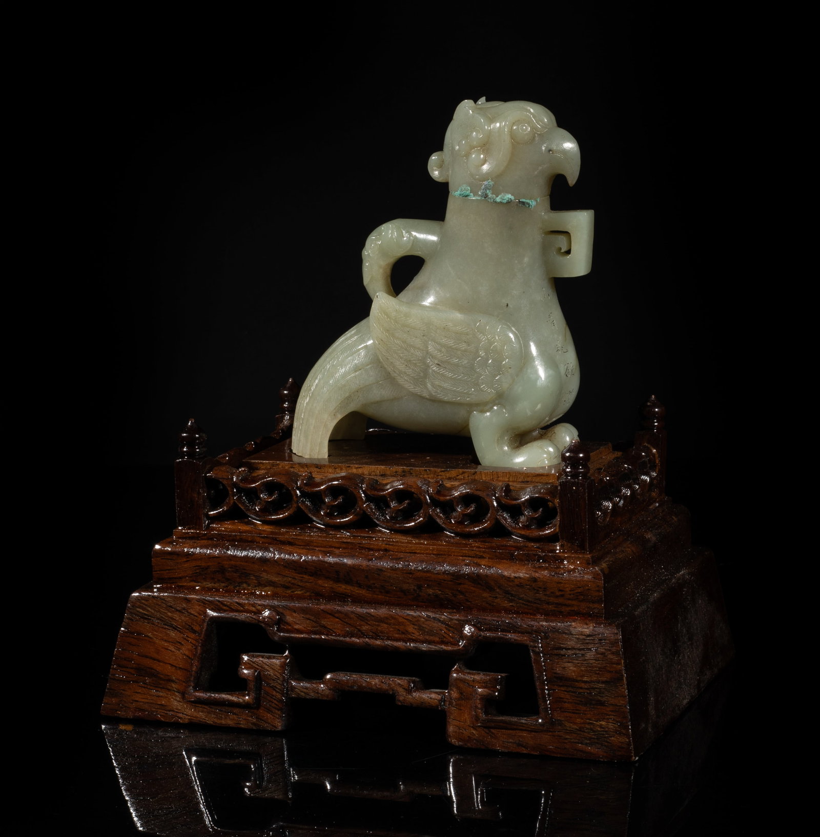 Chinese Jade Covered Vase on Lg Wood Base: Carved of archaistic bird form, detailed with finely incised wings and tail, an elephant head issuing from the bird back forming the handle, the chest inscribed with poems, with a matched wood stand.