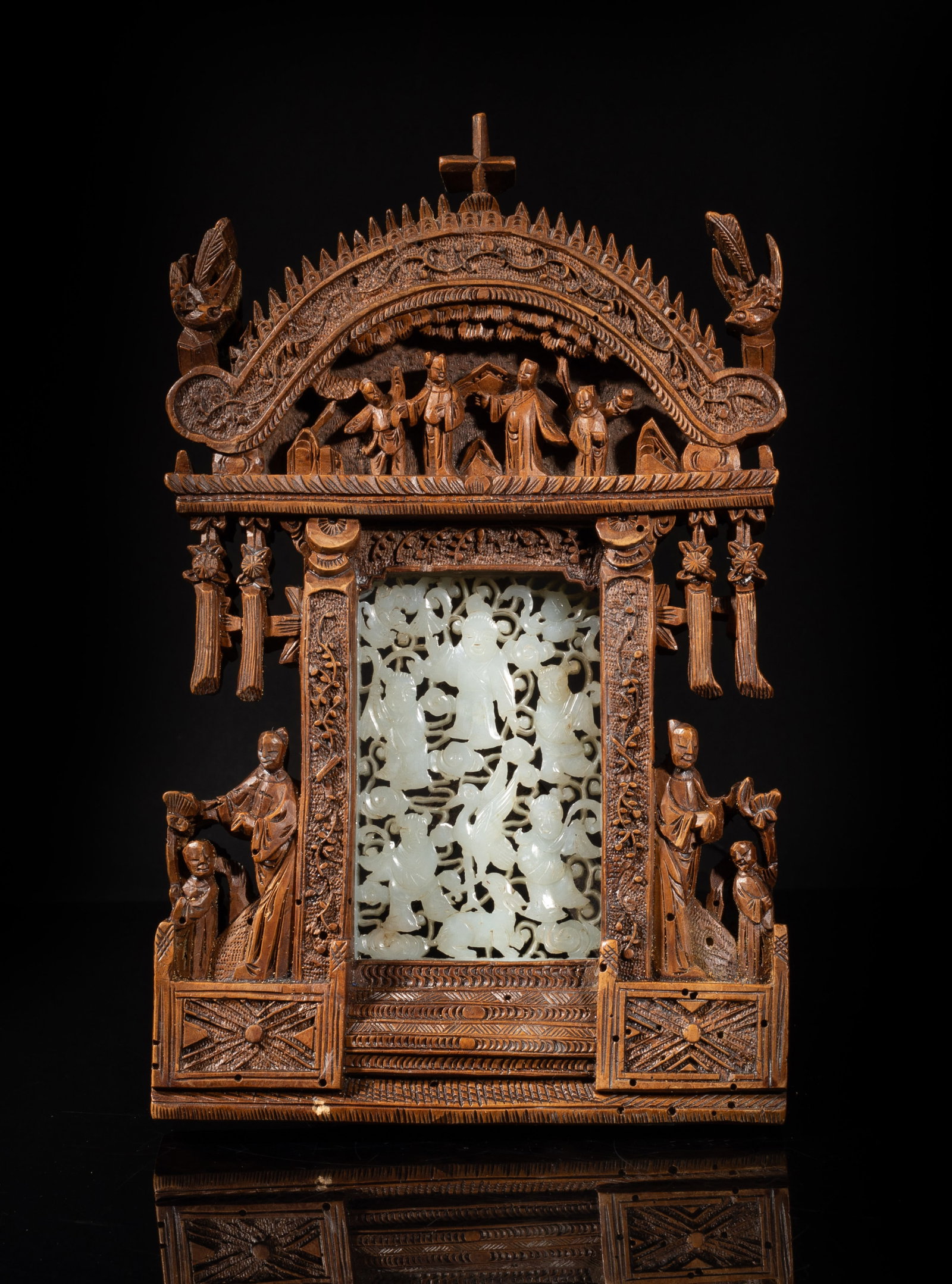 Rare Chinese Wood, White Jade Sculpture: Chinese wood table decor of gate form, carved with figures in various activities, inlaid with a jade plaque at the centre, carved and reticulated with five figures, a crane and a deer among lingzhi