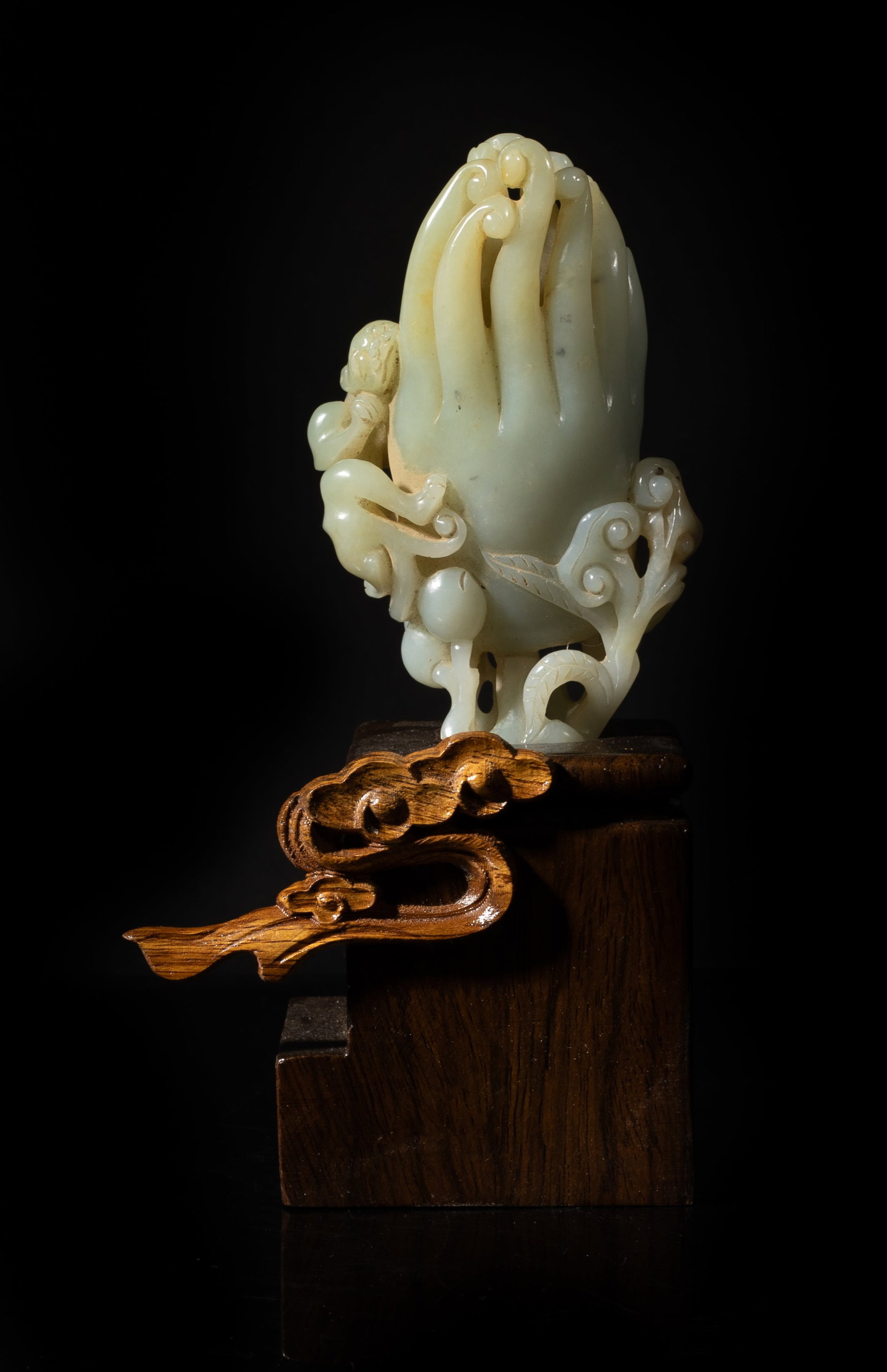 Estate Chinese Jade Buddha Hand Vase on Stand: Naturalistically worked as a cluster of a finger citron,with elongated thick tendrils with curled ends, issuing from an openwork of gnarled branches bearing further peaches and lingzhi fungus, a