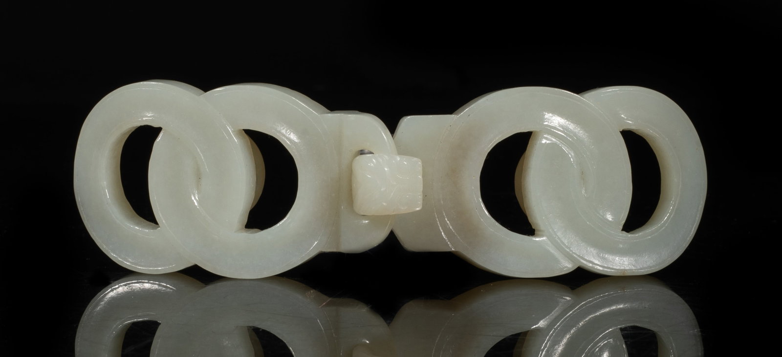 Estate Chinese White Jade Carved Belt Buckle: Of white tone and formed of two linking interlocking loops, the hook modeled in the form of a dragon head. Approx. 4.3*1.25 inch. The Estate of the Consignment Store Closed Sale, Palm Springs. CA.