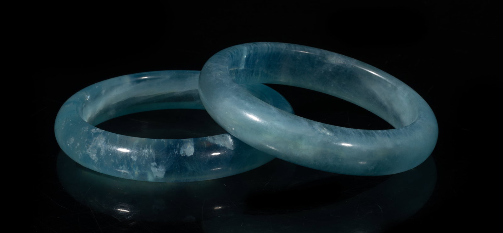 Two High Quality Chinese Aquamarine Bangles: Two collectible high quality aquamarine bangles. Approx. 3.03 inch outer diameter, 2.37 inch inner diameter (larger).