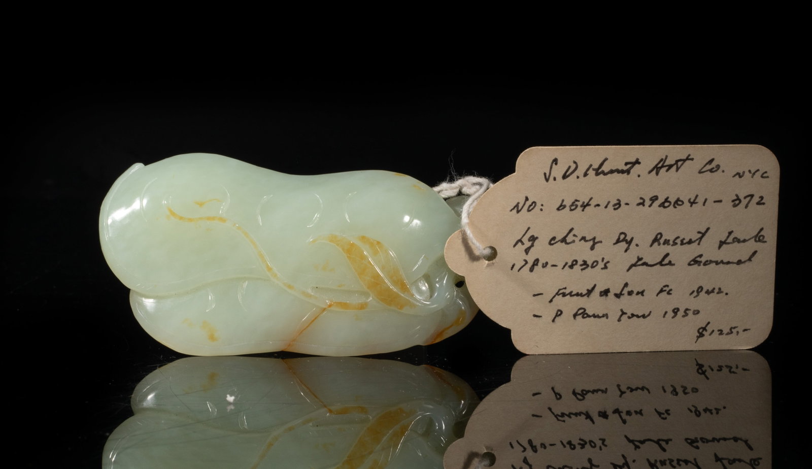 Chinese Russet Jade Gourd Form Pendant: Carved as two large gourds surrounded by leafy tendrils, the stone of pale celadon color with russet inclusions. Approx. 3.25*1.73*0.67 inch. The Estate of the J. D. Mart, Hollywood, CA. 2001,