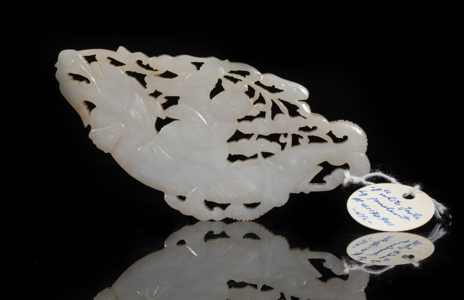 Chinese White Jade Carved Plaque: Large Chinese white jade plaque, carved in openwork with a boy riding a dragon, holding long lingzhi sprigs. Approx. 4.05*2 inch.