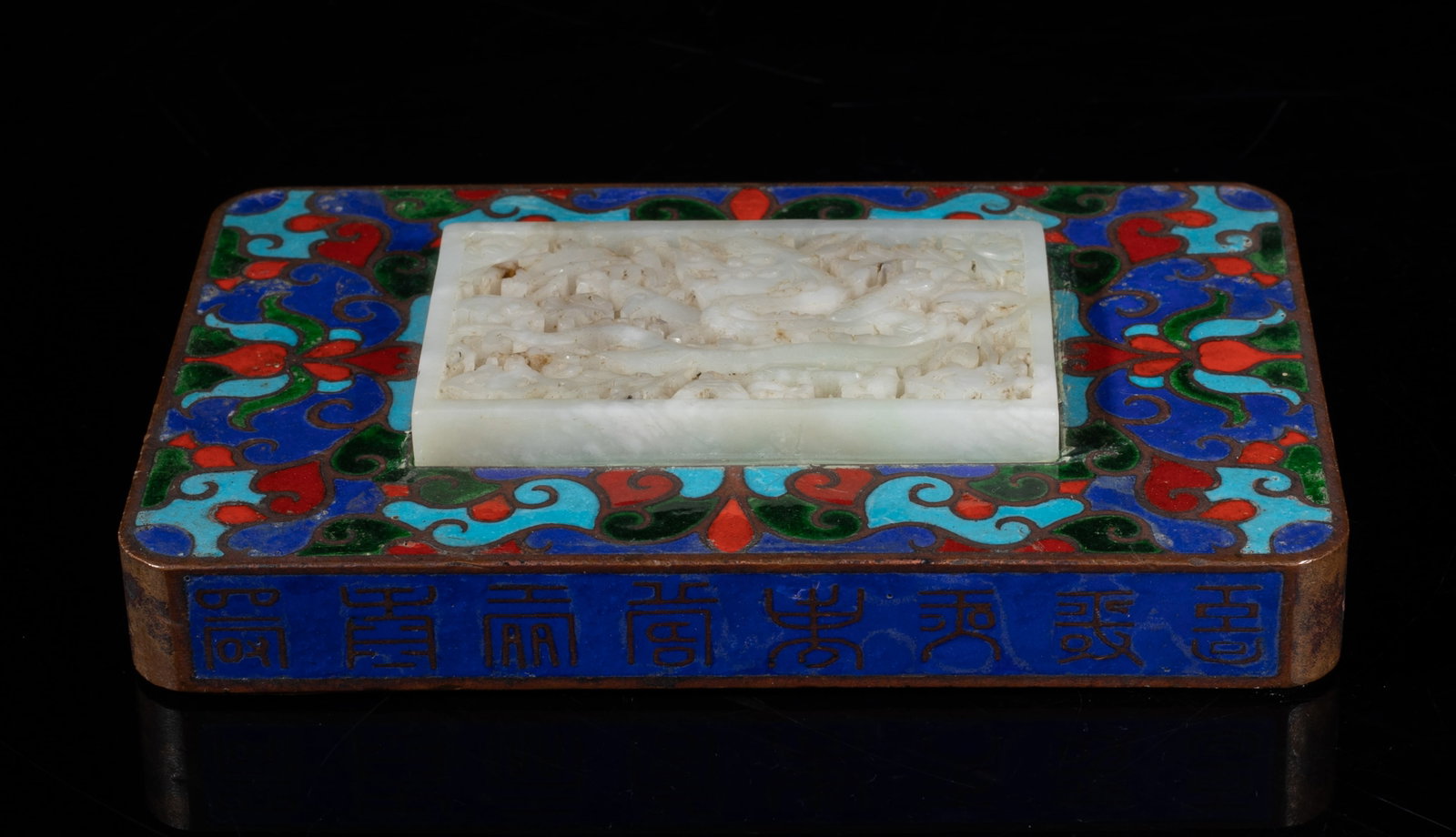 Designed Chinese Jade Dragon Plaque: Of rectangular shape, the top inlaid with a jade plaque carved in openwork with a dragon sinuous amidst flower and lingzhi sprays, enameled with stylized flowers in red, green, soft and dark blue
