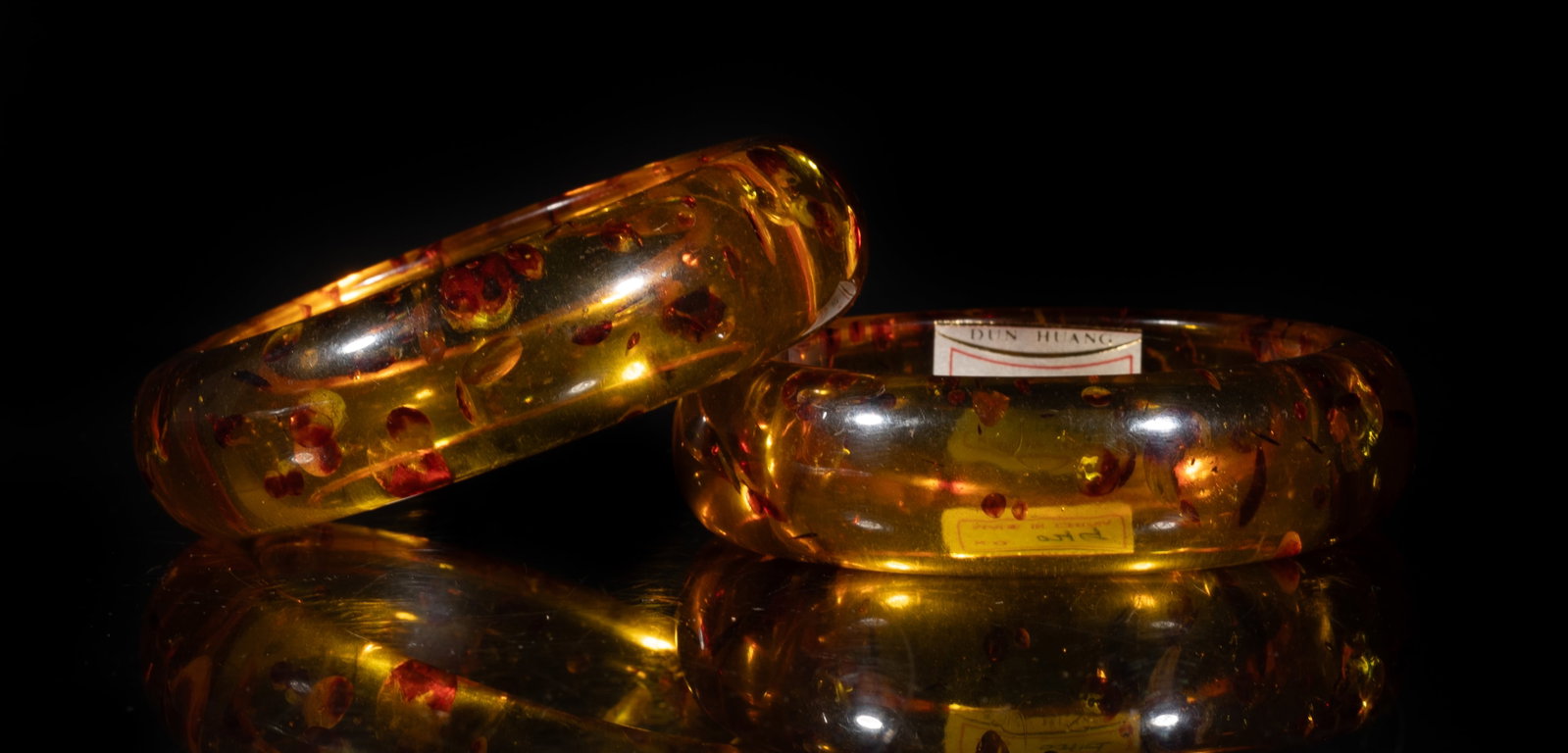 Two Large Vintage Chinese Amber Bangles: Two large vintage Chinese amber bangles. Approx. 108 gram, 3.38 inch outer diameter, 2.5 inch inner diameter (larger bangle).
