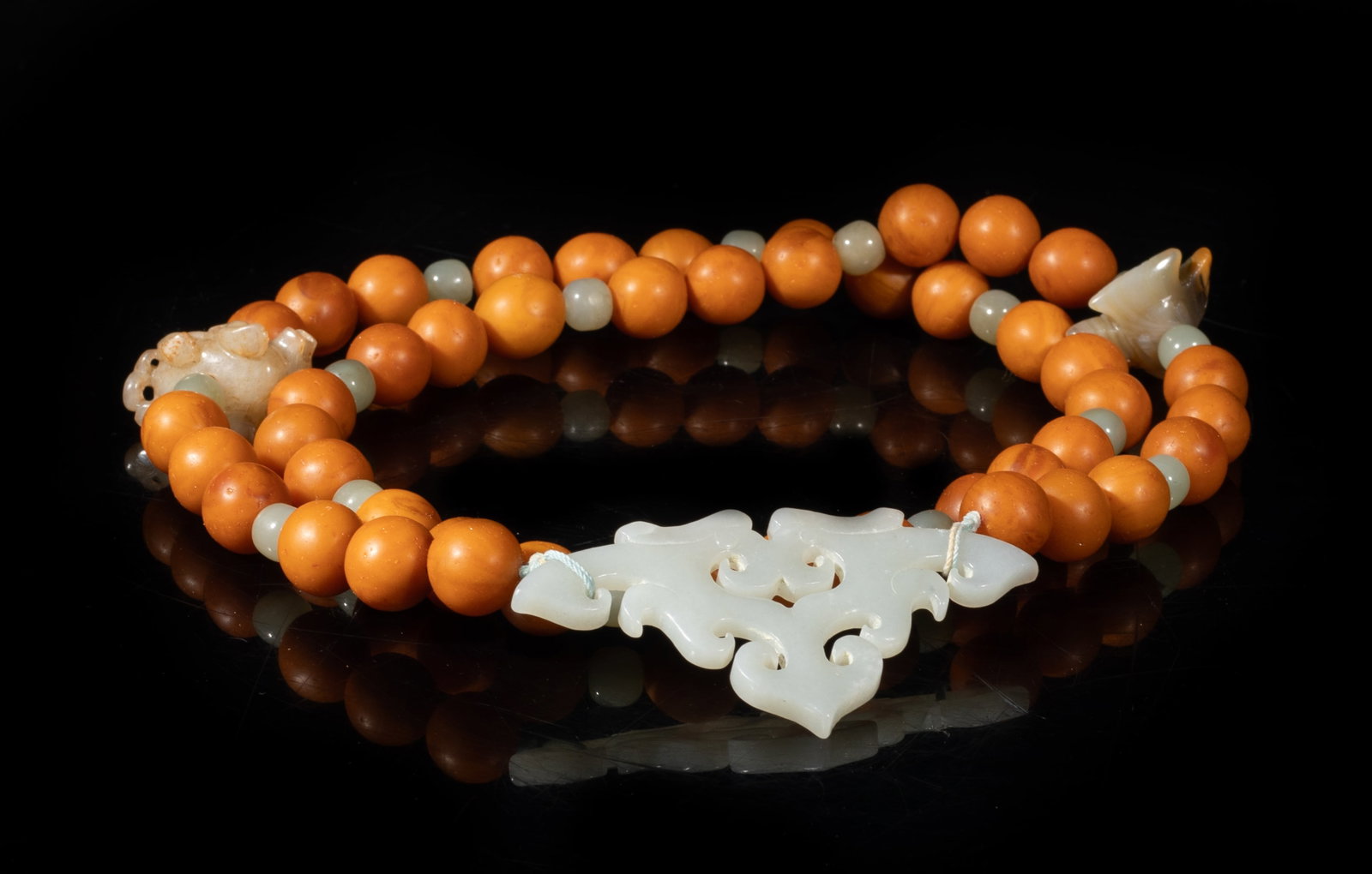 Vintage Chinese Export Amber, Jade Necklace: Chinese amber and jade bead necklace, with an agate carved bird, a russet jade beast, and a jade pendant. Approx. 28 inch L.