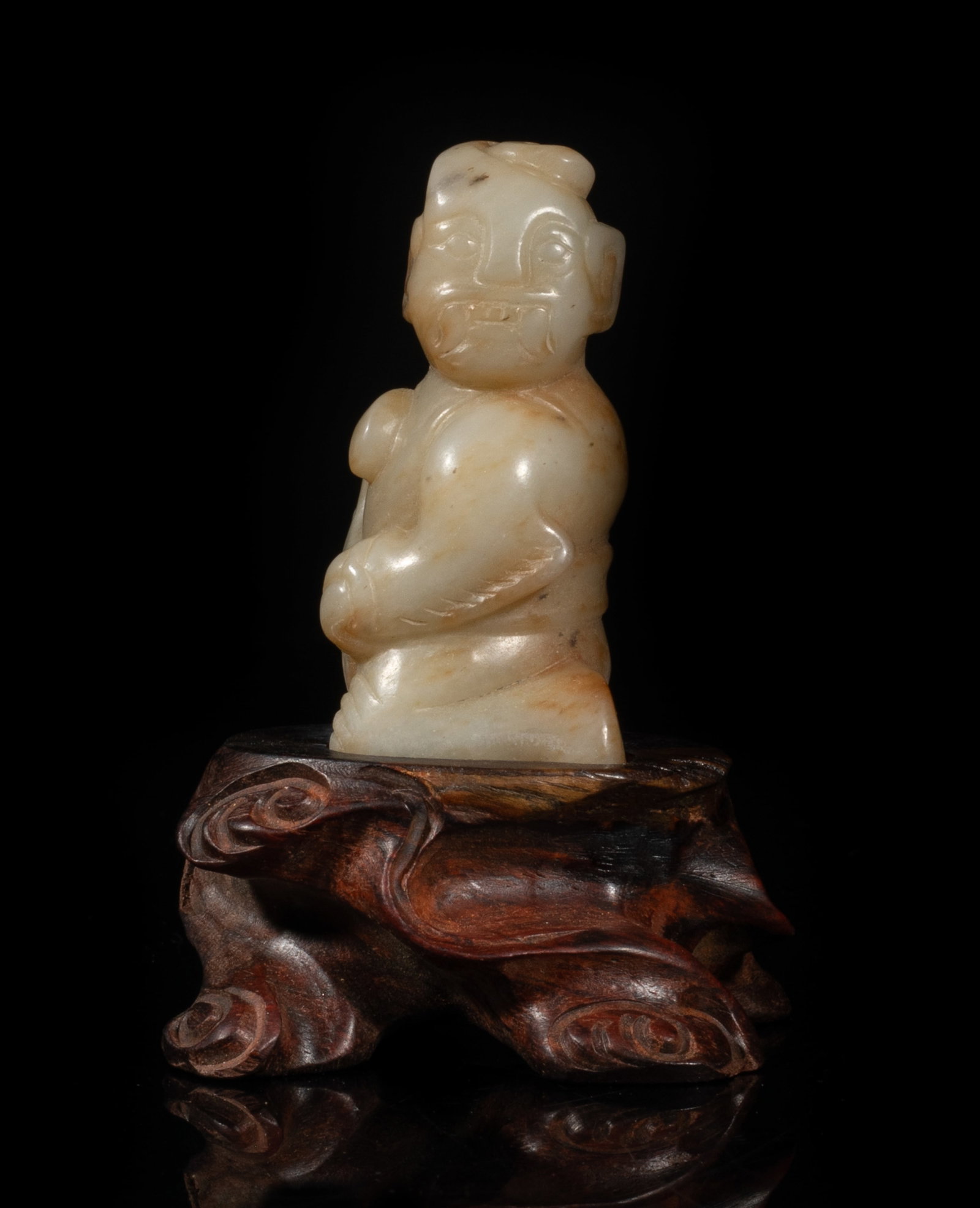 Estate Chinese Jade Figure on Wood Base: Chinese russet jade carved as a figure kneeling on left knee, holding an instrument in his hand, his head facing left, with wood stand. Approx. 3.07*2.1*2 inch (w/ stand). The Estate of the Ales. F. H