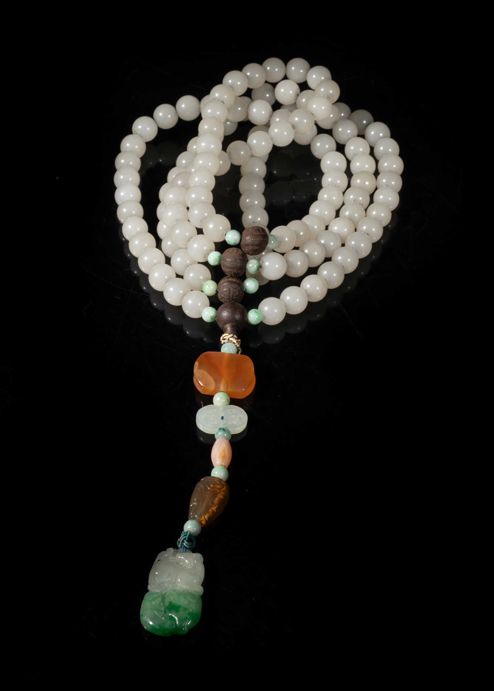 Estate Chinese Jade Prayer Beads: A long string of Chinese jade prayer beads, with wood beads, agate pendants, and a pendant carved with deer, lingzhi and peach. Approx. 50 inch L.