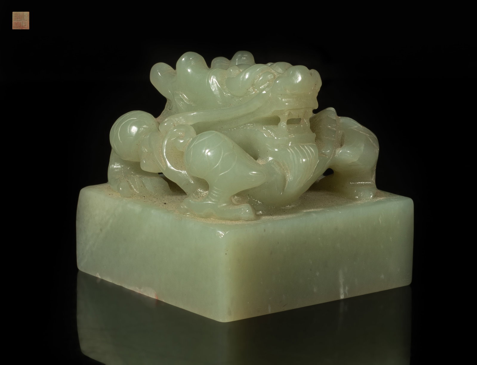 Estate Chinese Jade Carved Dragon Seal: The almost square seal surmounted by an openwork coiling dragon, boldly carved with a scaly body, his head raised ferociously with bulging eyes. Approx. 2.18*2.1*2.05 inch.