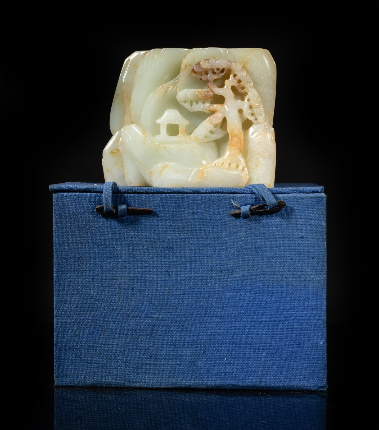 Estate Chinese Russet White Jade Sculpture: Worked in varying levels of relief to depict craggy mountains, one side carved with a sage under a gnarled pine tree, the reverse finished as faceted rock formations supporting a tall pine tree above 