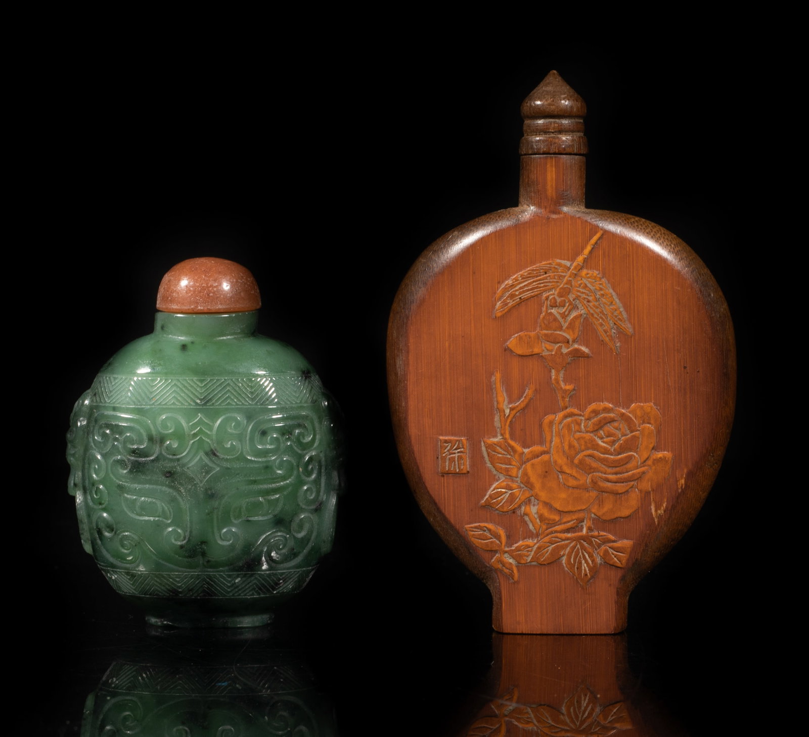 Chinese Spinach Jade, Bamboo Snuff Bottles: The flattened bamboo snuff bottle carved with flower and dragonfly, the spinach jade snuff bottle of ovoid shape, carved on either side with a taotie mask, flanked by two faux-ring masks, each with a