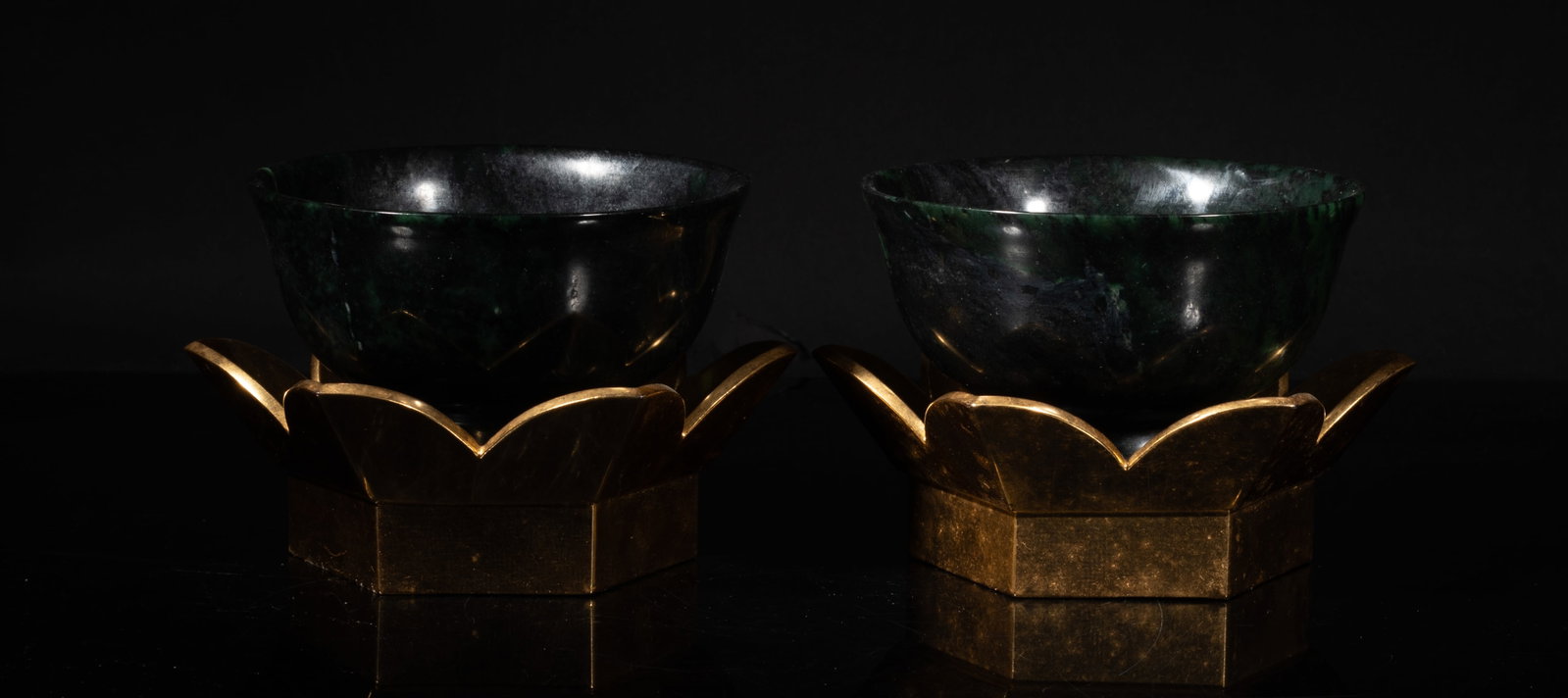 Two Chinese Large Spinach Jade Bowls: Two Chinese large spinach jade bowls, the surface finely smoothed and polished, with floral form stands. Approx. 4.7*2.5 inch (each).