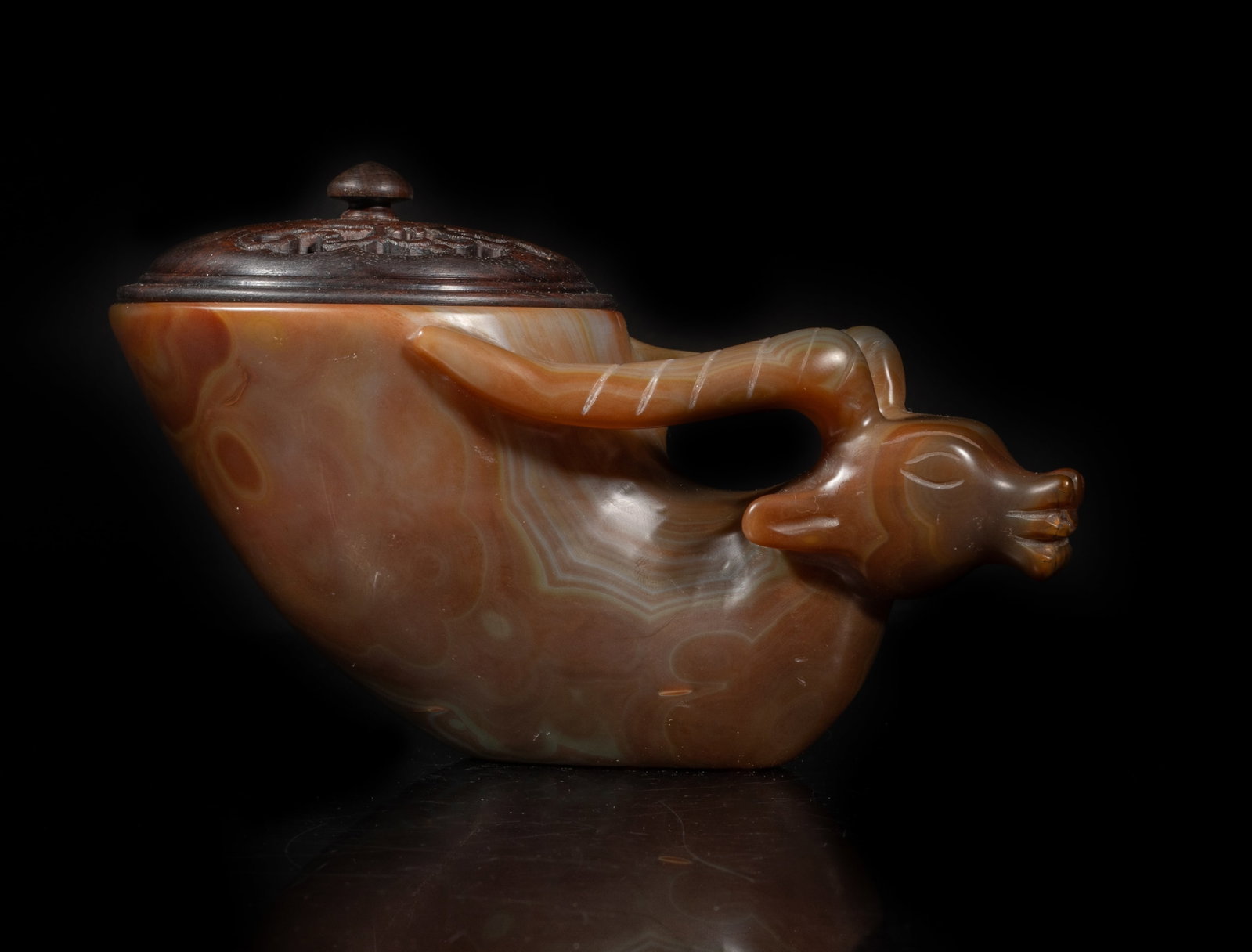 Estate Large Chinese Cameo Agate Cup: The cameo agate cup carved with a goat head forming as a handle, the surface finely smoothed, with an openwork wood lid. Approx. 6.6*3.4*3 inch (w/o lid).
