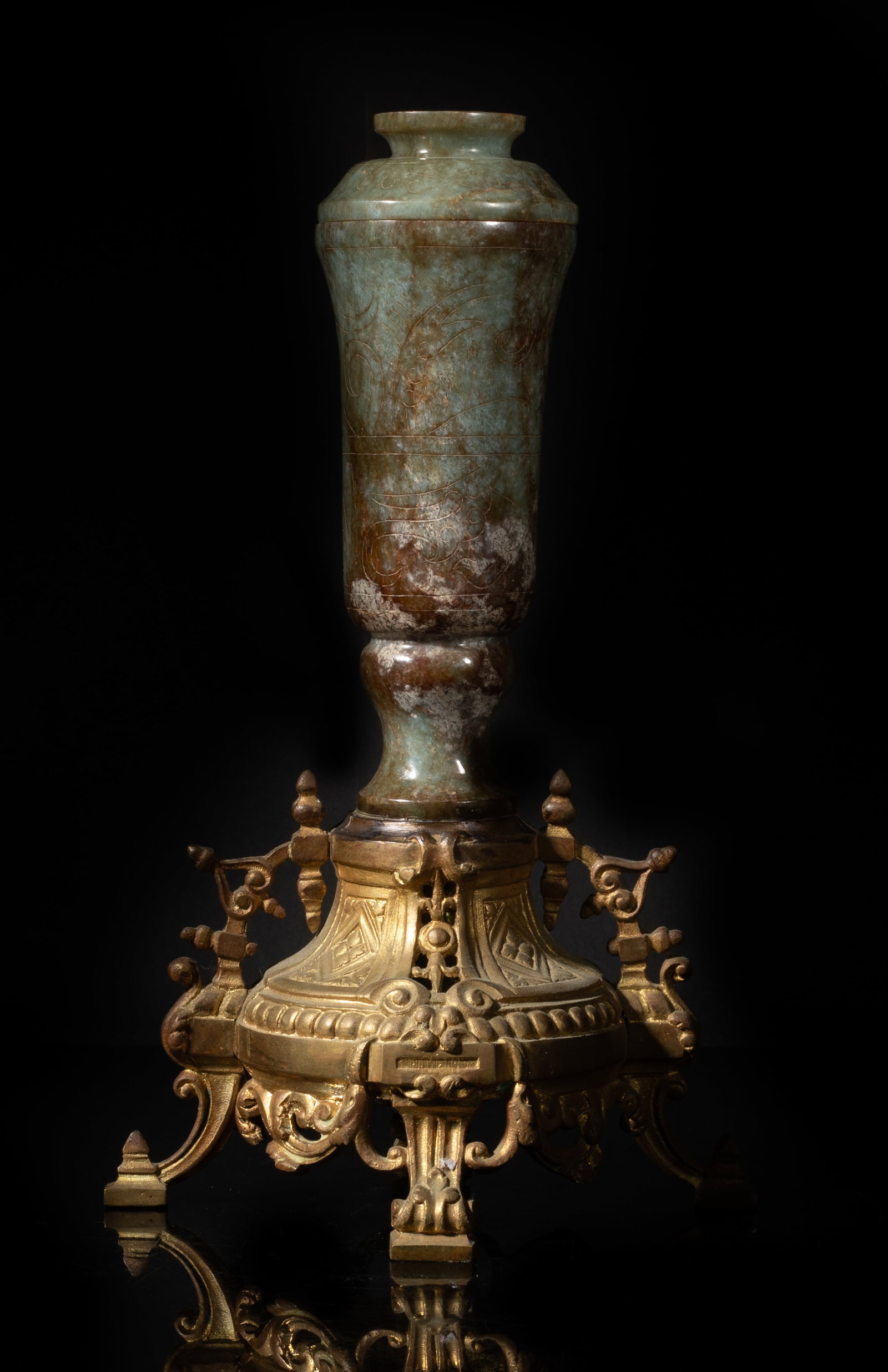Tall Early 20th Chinese Export Jade Vase: Tall Chinese russet jade covered vase, the exterior incised with stylized beast, supported on a delicate metal base. Approx. 11*6.6*5.2 inch.