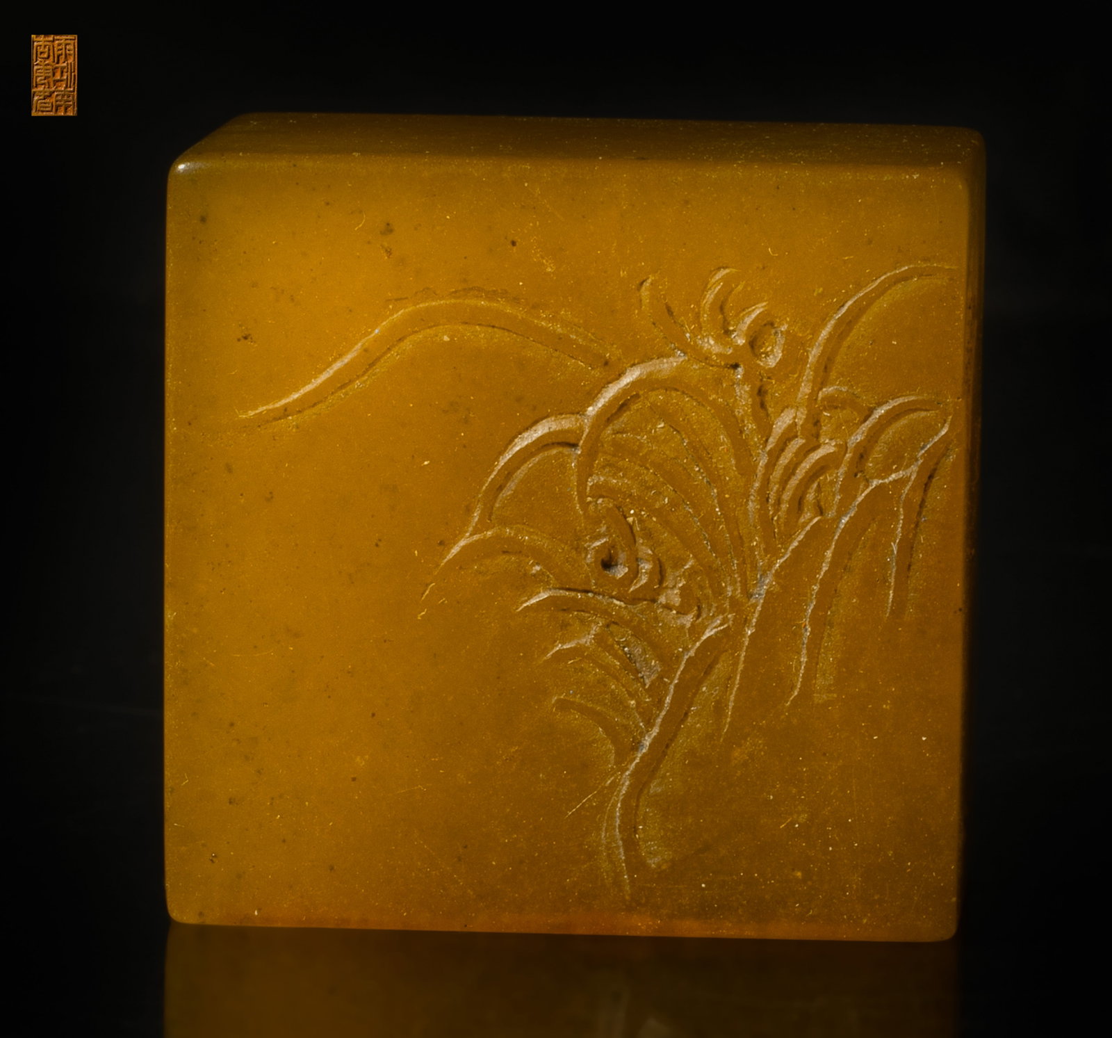 Rare Chinese Translucent Tianhuang Stone Seal: Of rectangular section, one side carved in low relief with orchid, the reverse side incised with inscription. Approx. 1.4*1.37*0.82 inch.