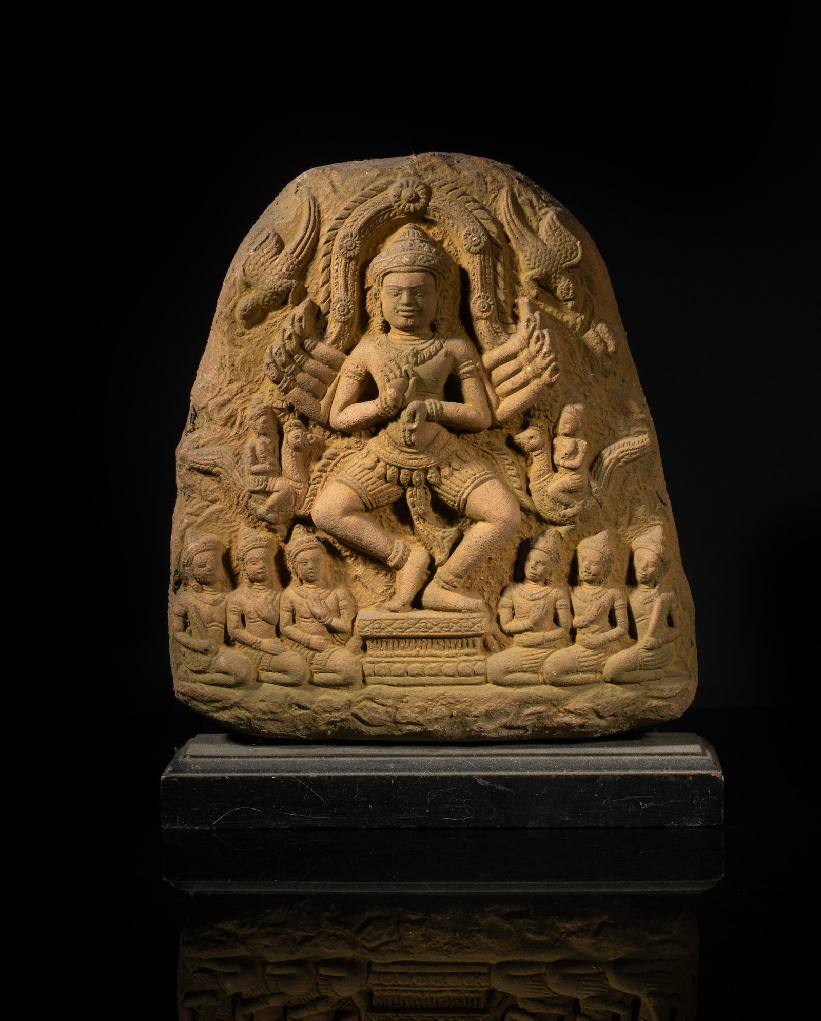 Antique South Asian Stone Buddha: The flat stone carved with a Buddha in dancing pose, the multiple pairs of hands in elegant mudra, flanked by two birds, two Buddha riding on birds and six attendant kneeling Buddha. Approx. 10.7*9*2.
