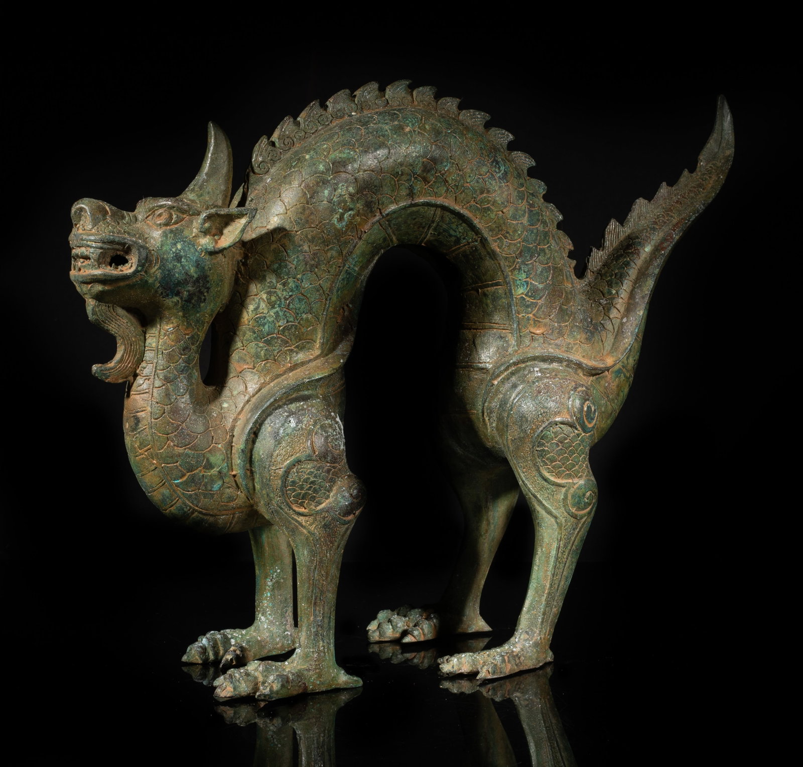 Large Chinese Bronze Dragon Sculpture: The single-horned dragon cast with a long curled scaly body, four strong legs and claws supporting the body. Approx. 9.7*12.7*4 inch. The Estate of the Store Closed Sale, Palm Springs, CA. 2022.